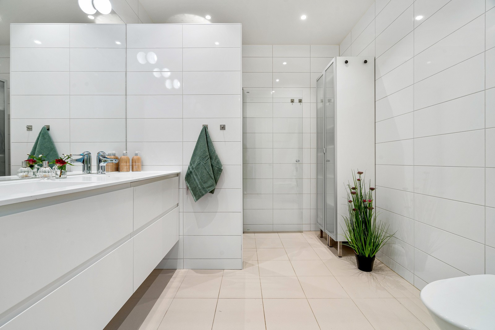 Videre er badet innredet med toalett og dusjhjørne.