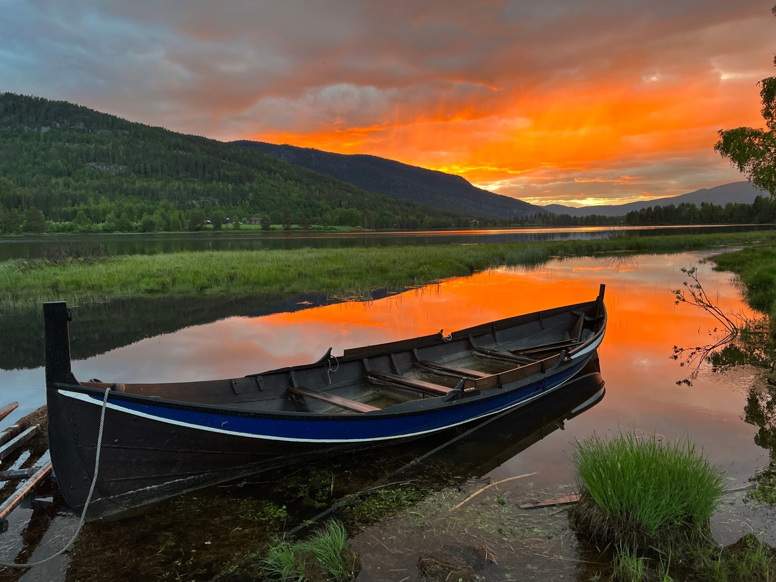 Trebåten i solnedgang på elven. Gårdens beliggenhet helt ned mot elven er unik. Avstanden til naboer er stor og man opplever å være svært skjermet/meget privat. Galleribilde