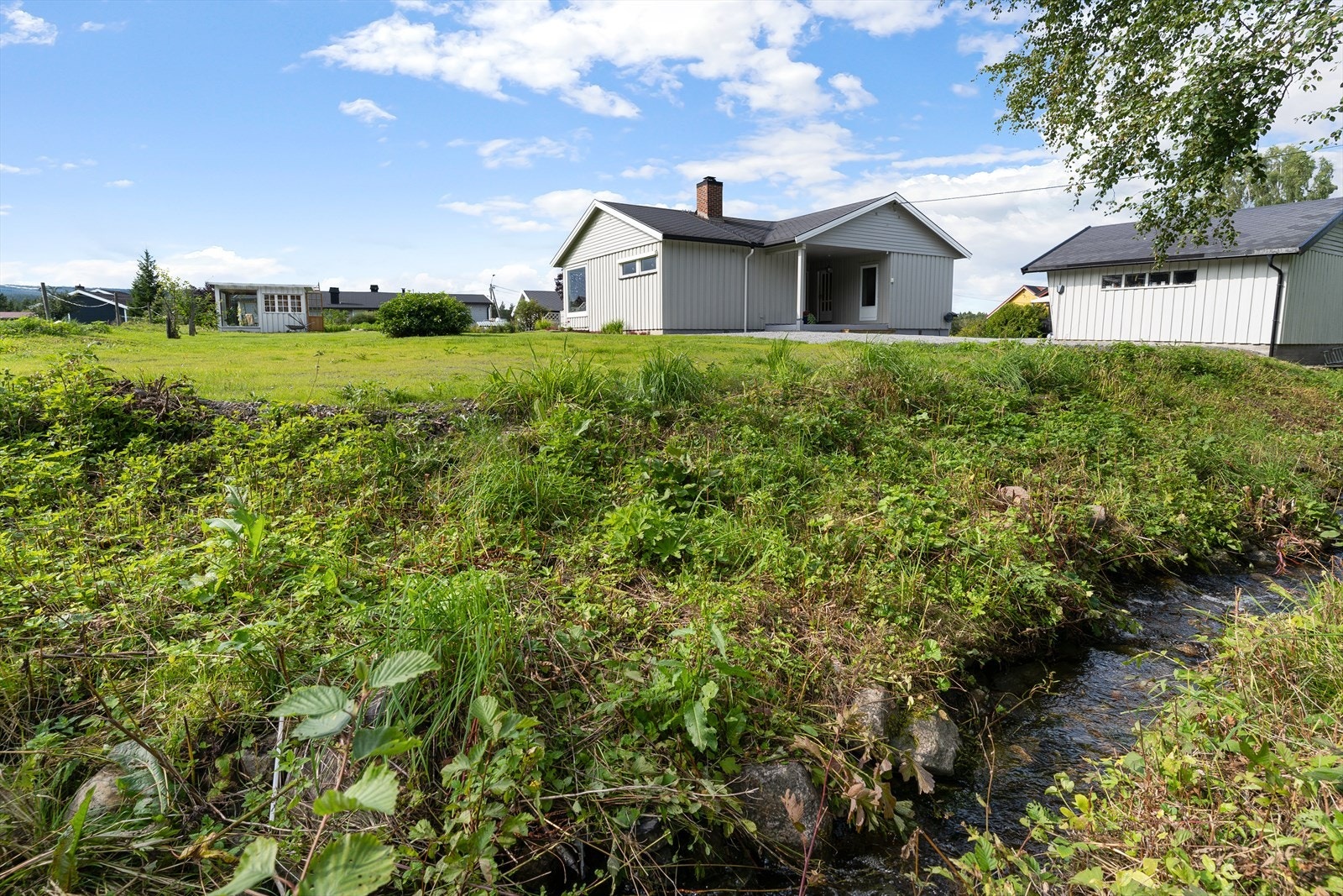 Ved siden av tomta renner det en koselig liten bekk. Galleribilde