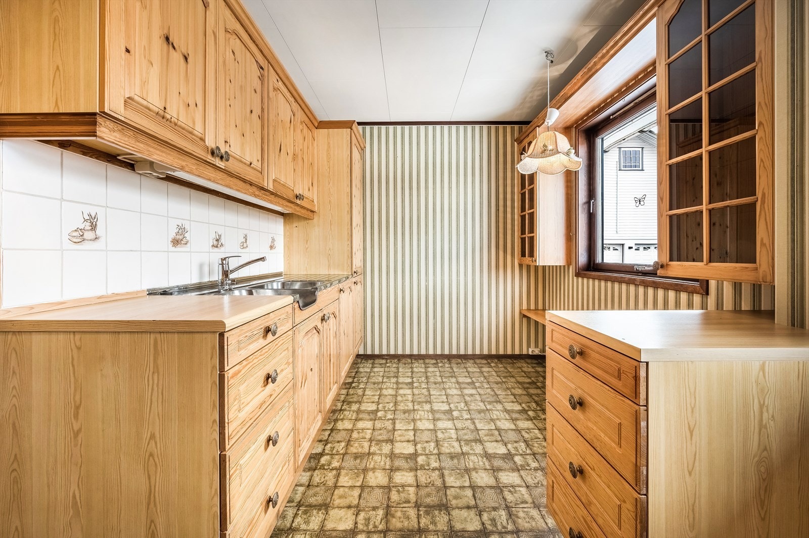 Kjøkkeninnredning bestående av benkeskap, overskap og høyskap. Galleribilde