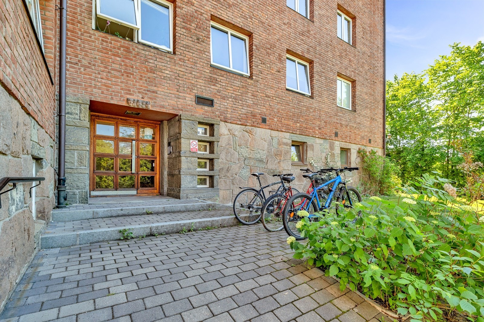 Hyggelig og forseggjort inngangsparti med sykkelparkering utenfor Galleribilde