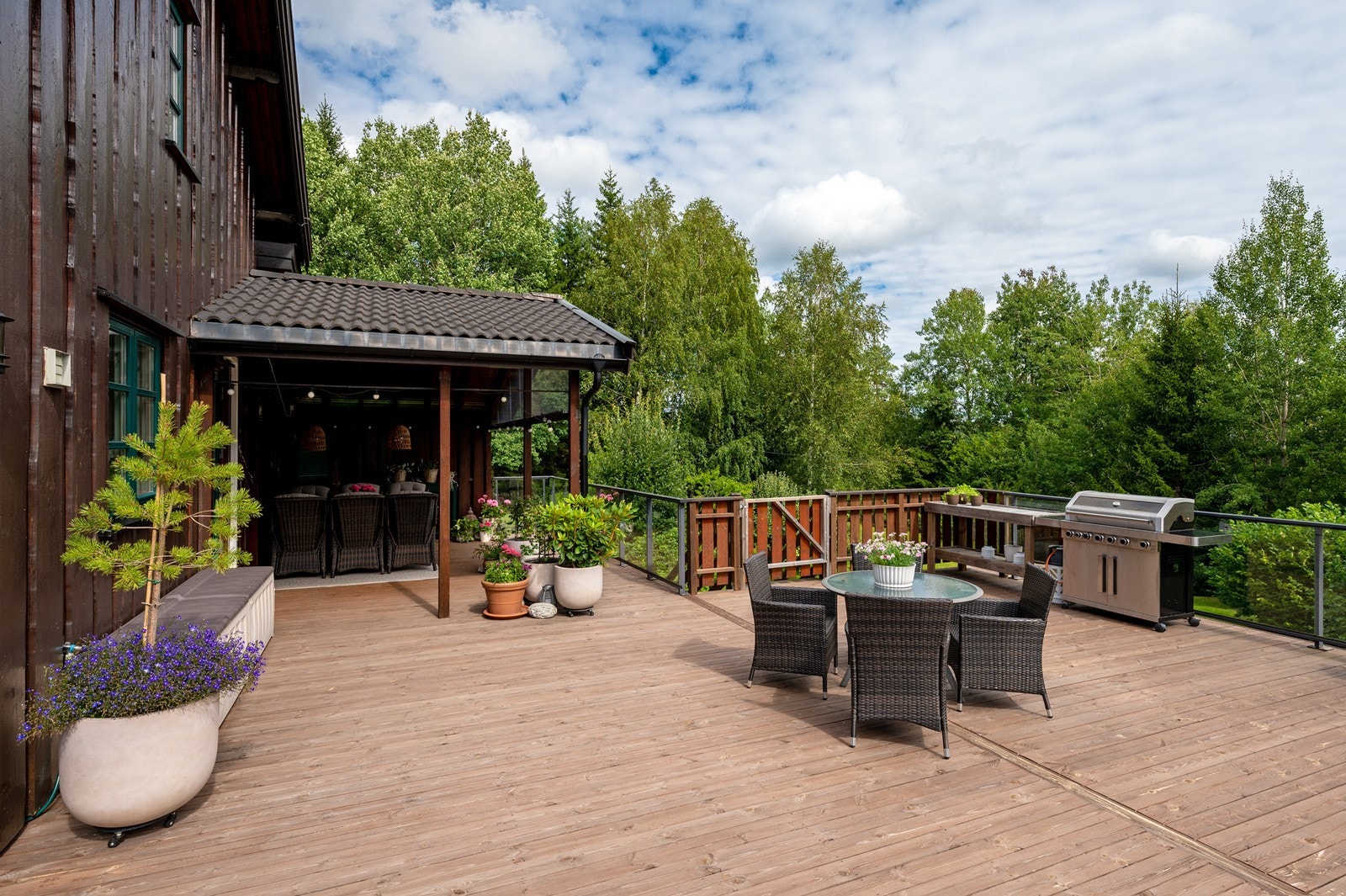 Fra kjøkkenet er det utgang til terrassen, og under taket er det perfekt å ha spisebord. Galleribilde