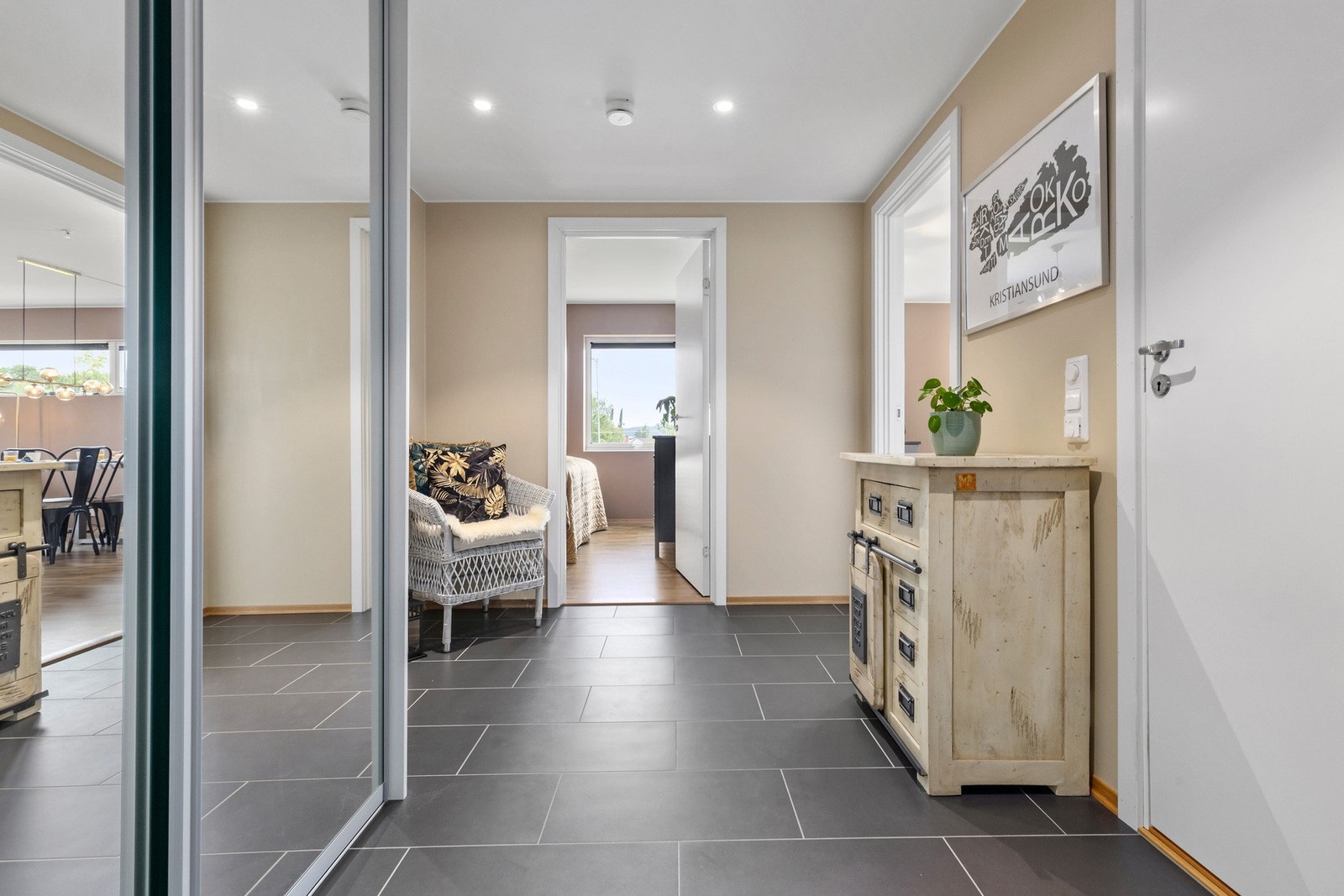 Flislagt entrè med varmekabler i gulv. Praktisk skyvedørsgarderobe og downlights i himling. Leiligheten har en innvendig bod på ca. 3,4 kvm som er lokalisert til venstre i dette bildet. Galleribilde