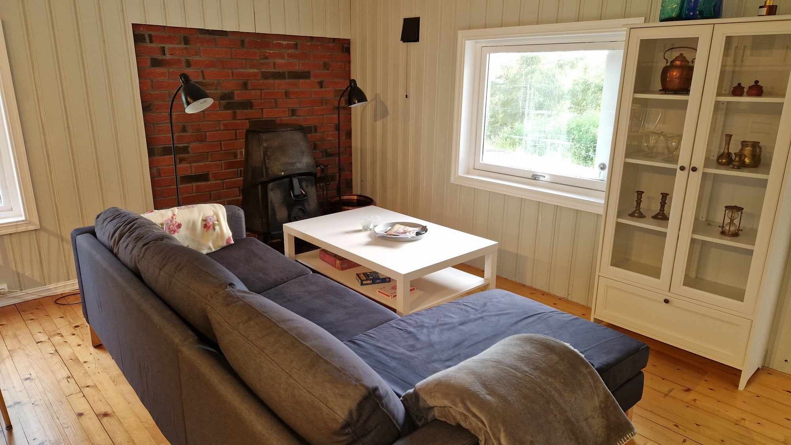 Kjøkken/Stue med en sofa og vedovn Galleribilde