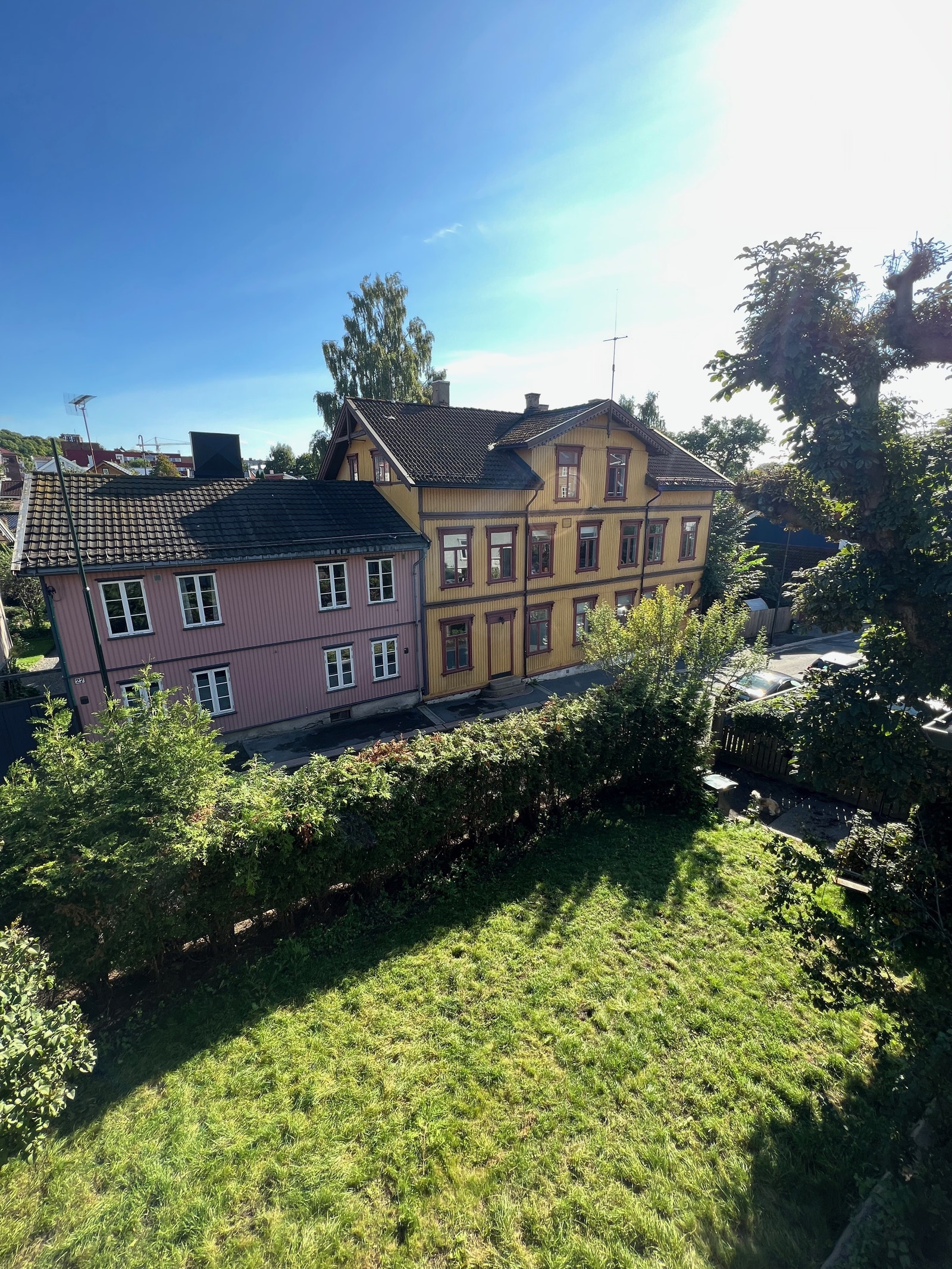 Utsikt fra stue til hagen og hyggelig trehusbebyggelse Galleribilde