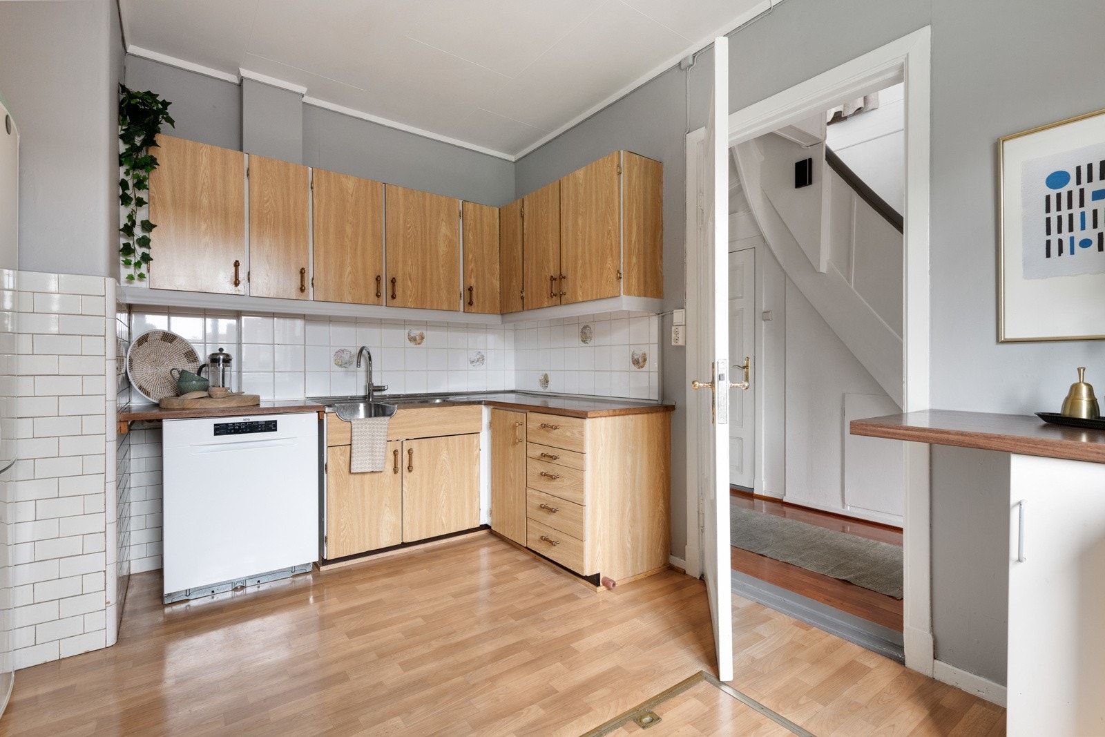 Kjøkken med adkomst fra gang. Kjøkkenet har rikelig med skap og benkeplass. Galleribilde