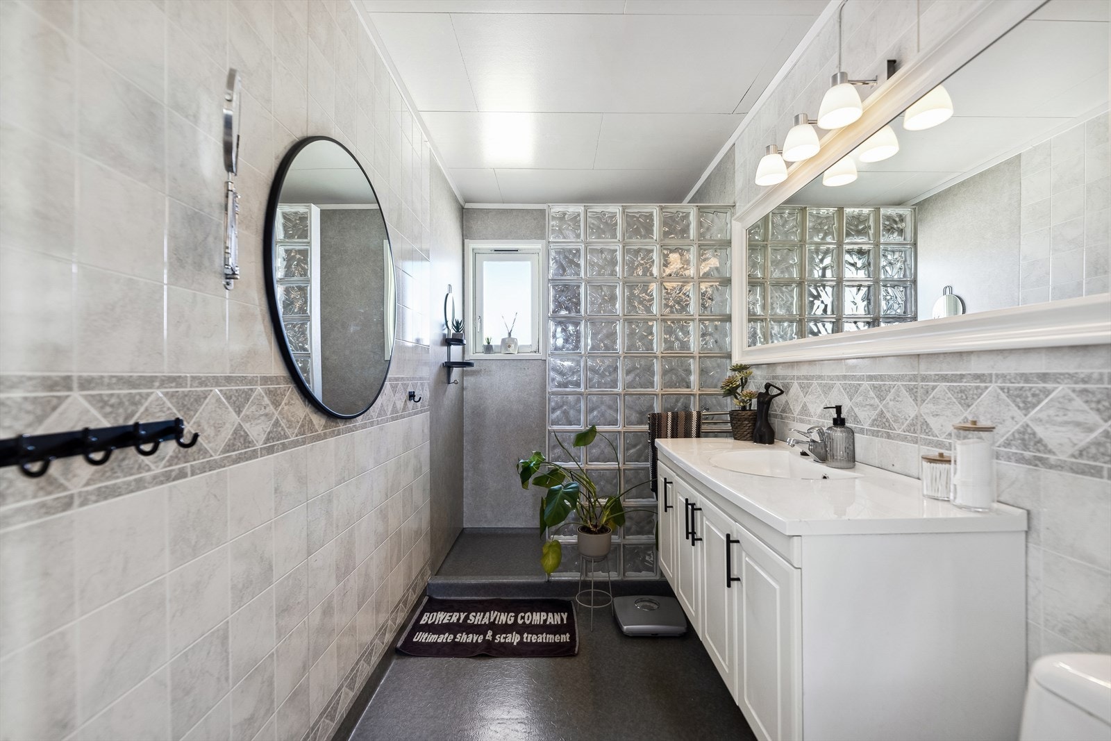 Badet er utstyrt med dusj med dusjvegg, lys romslig baderomsinnredning og wc. Galleribilde