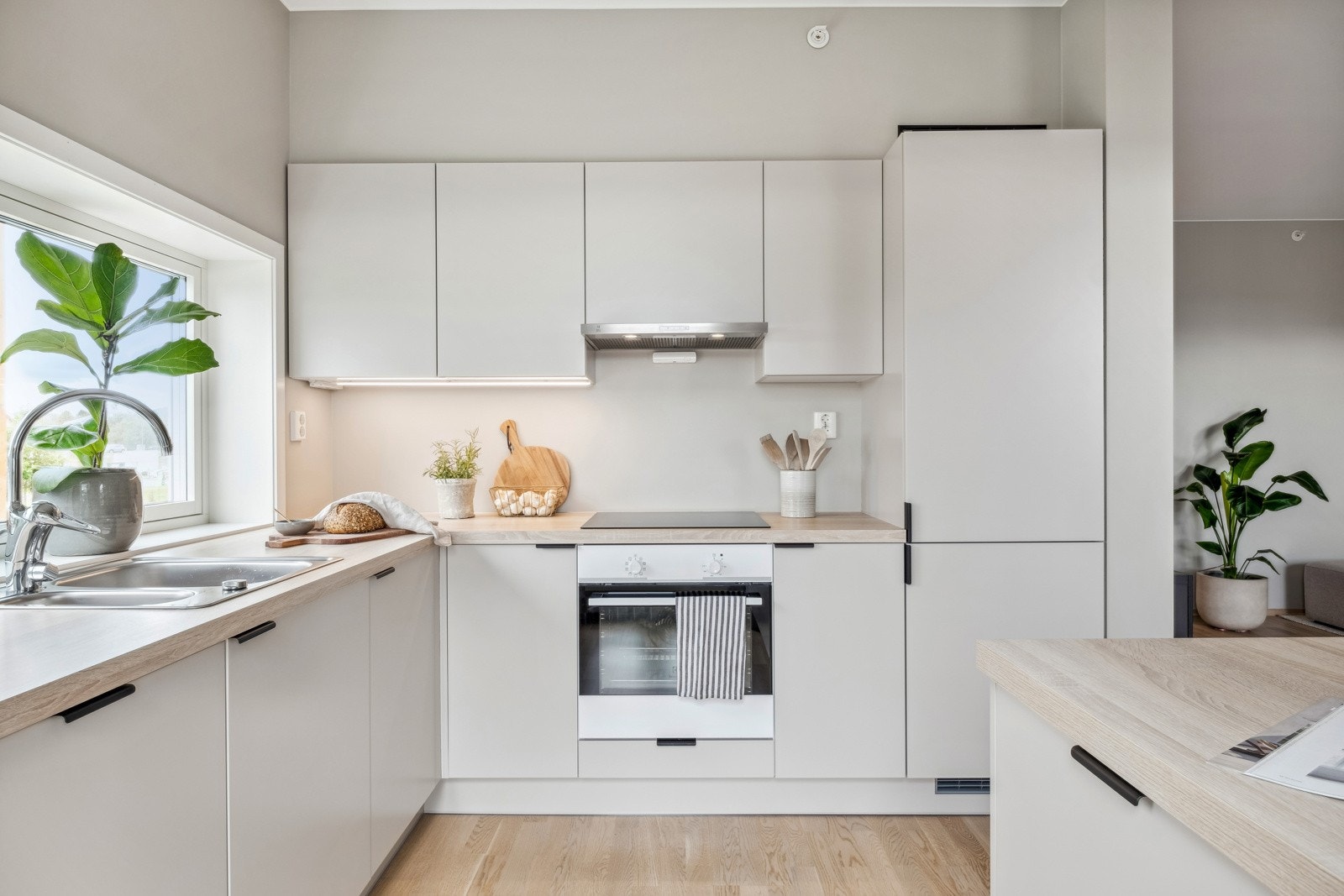 Leiligheten har et moderne kjøkken i nordisk stil med integrerte hvitevarer. Galleribilde