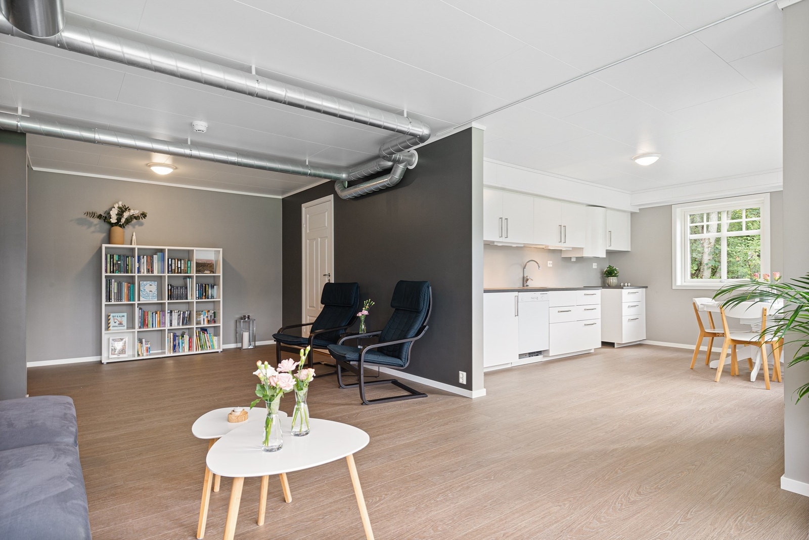 Det er åpen løsning mellom stue og kjøkken i underetasje. Ventilasjonsrørene kan kasses inn om ønskelig. Galleribilde