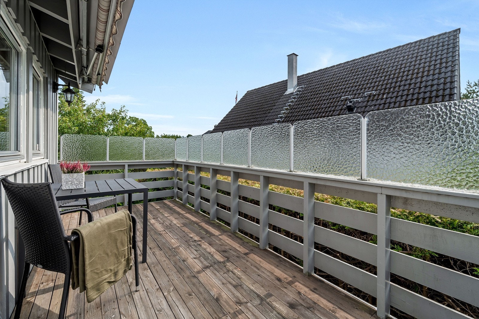 Adkomst fra stuen til en sydvendt veranda på ca. 11 kvm med markise og trapp ned til hagen. Galleribilde