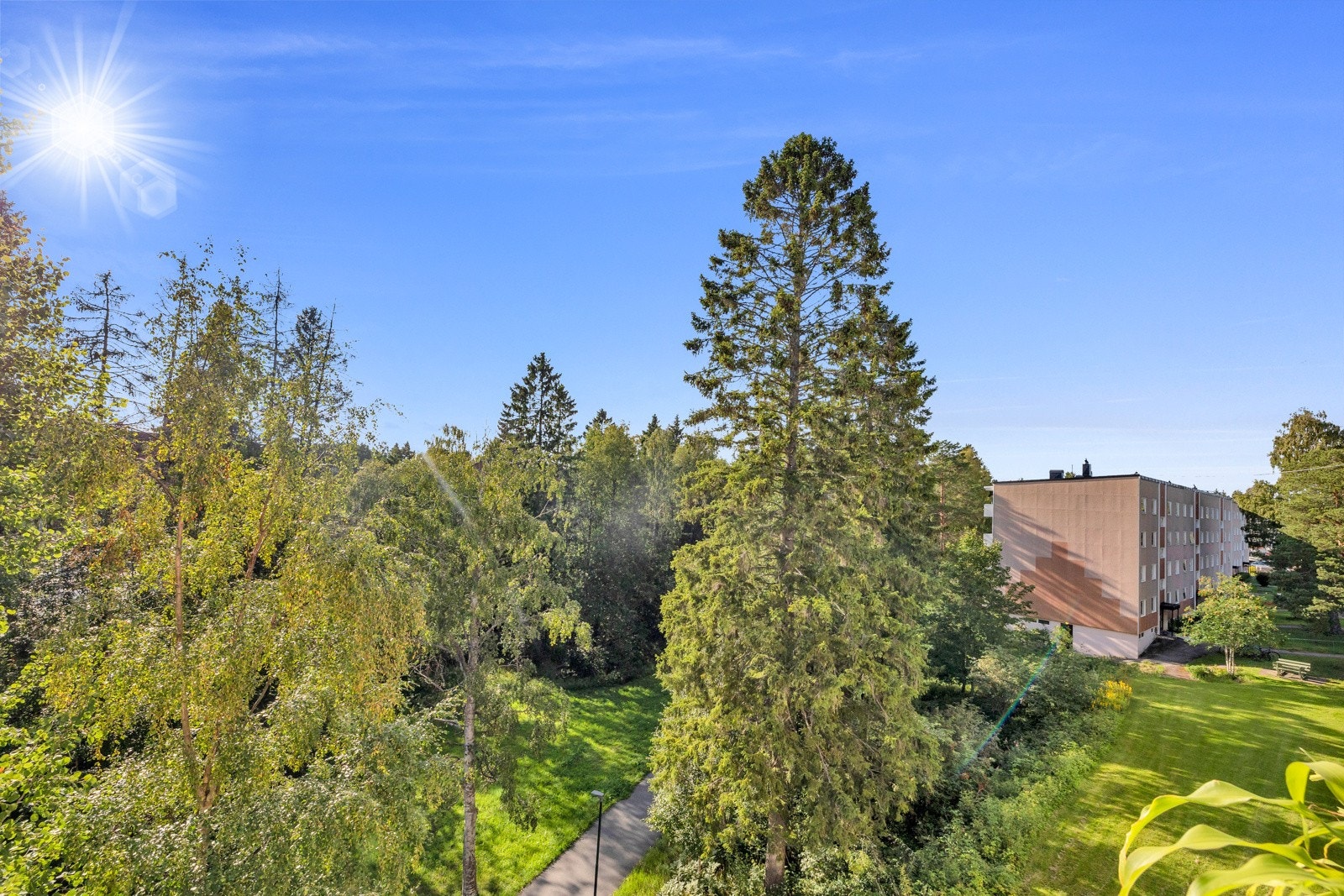 Det er luftig utsikt til flott grøntareal fra balkongen Galleribilde