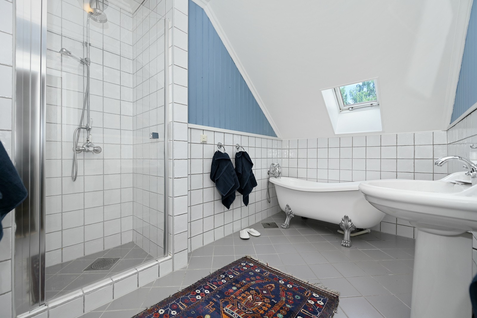 Dette badet har frittstående servanter, dusjnisje og et frittstående badekar med løveføtter. Galleribilde