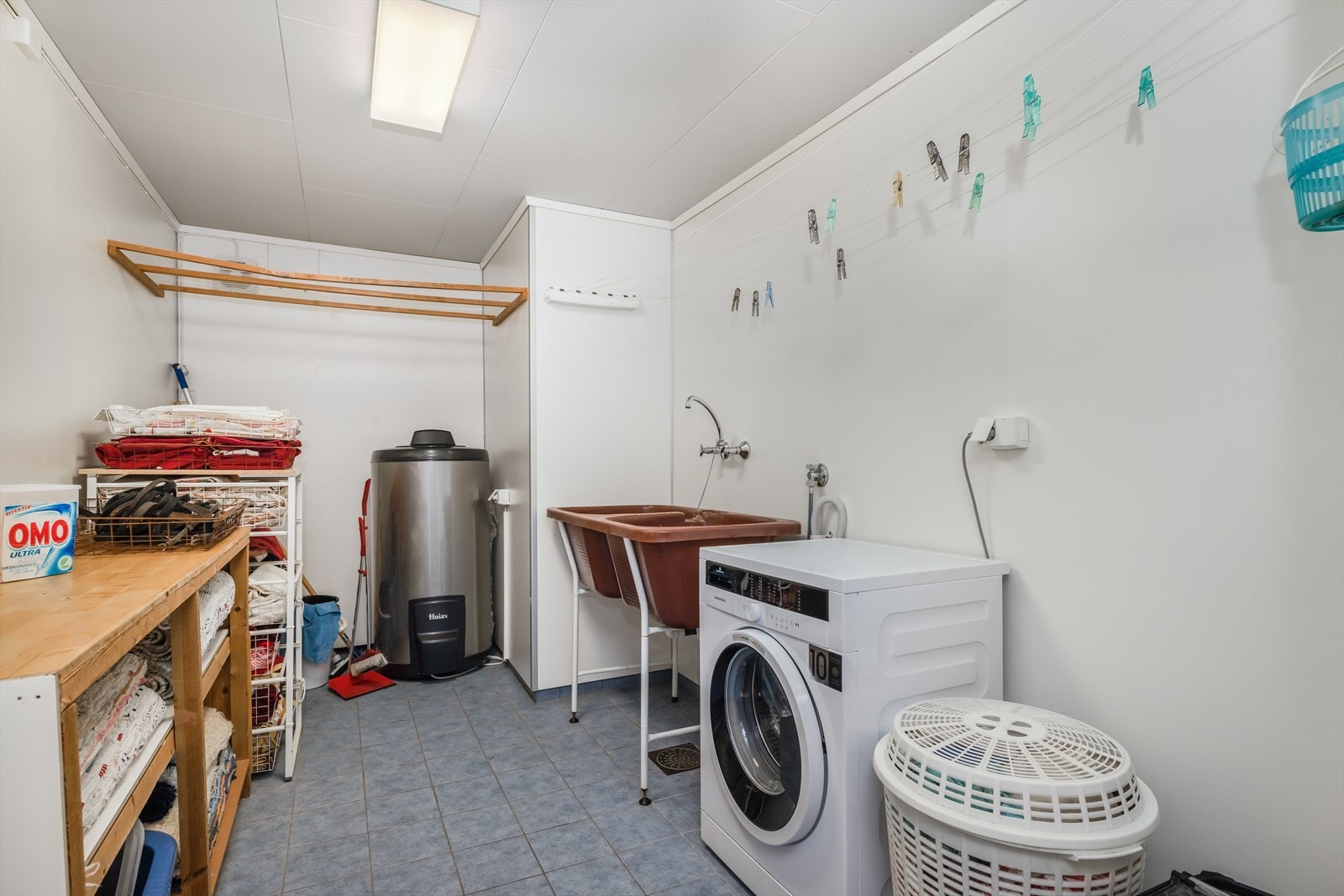 Eldre vaskerom som er renovert i 2011 med nye våtromsplater. Det er flis på gulv og hvite takess plater i himling. Opplegg for vaskemaskin, dobbel vaskekum i plast montert i gulvstativ. Galleribilde