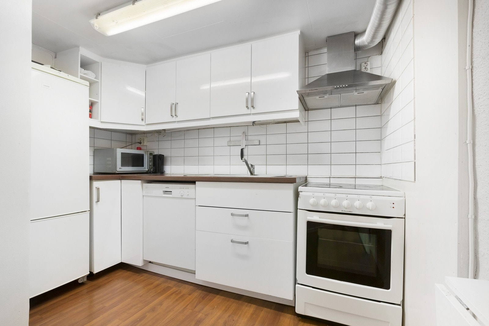 Kjøkkenet i kjelleren har rikelig med skap- og benkeplass. Det er innredet med kjøl/fryseskap, oppvaskmaskin og stekeovn med kokeplate. Galleribilde