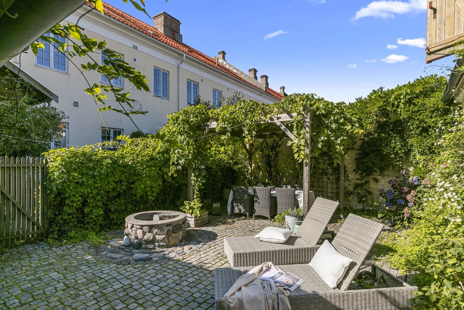 Her er det brostein, "brønn", utekjøkken, bod og pergola med vindruer - utrolig sjarmerende. Galleribilde