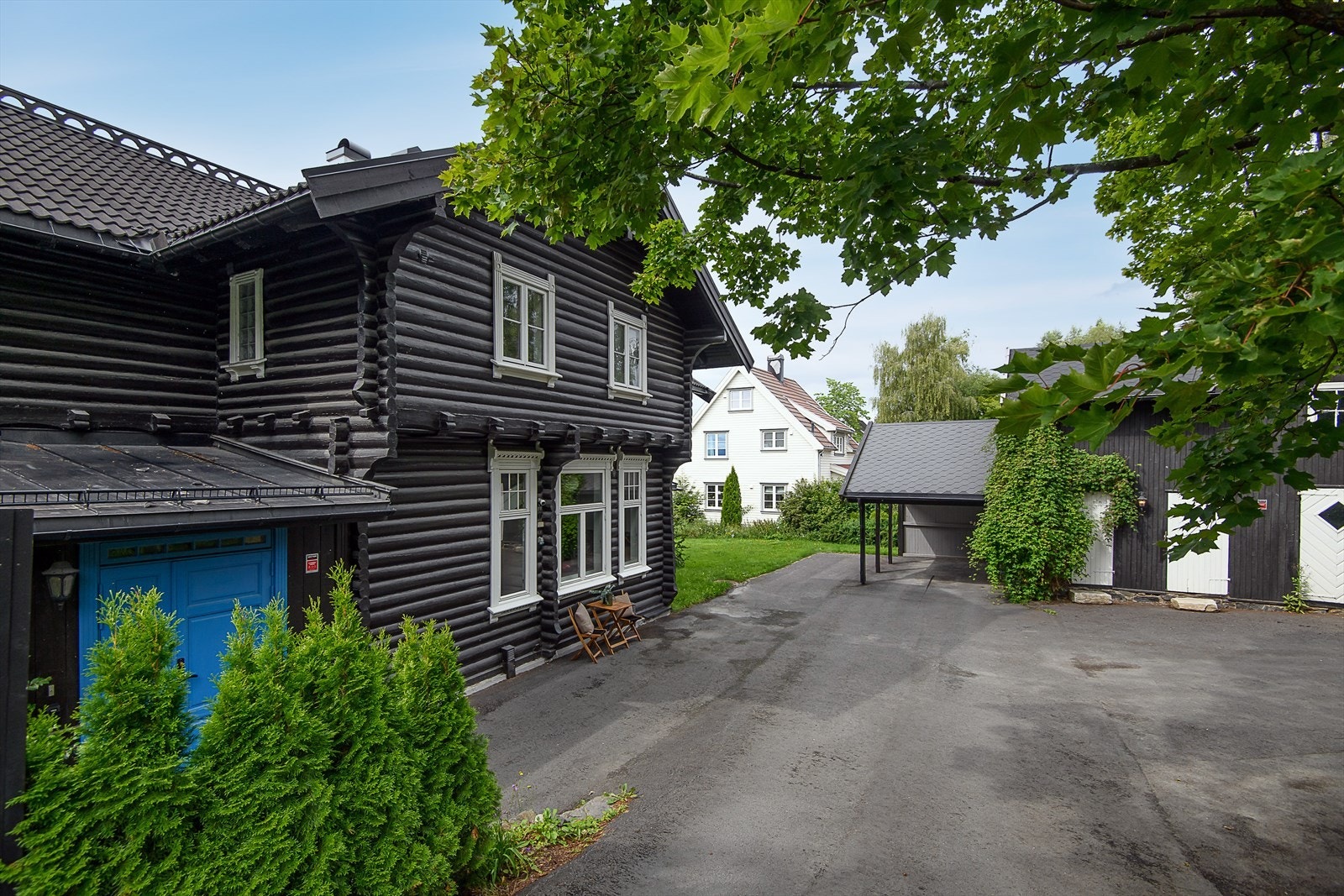 Asfaltert gårdsplass med gode parkeringsmuligheter i tillegg til carport i enden av uthuset. Galleribilde
