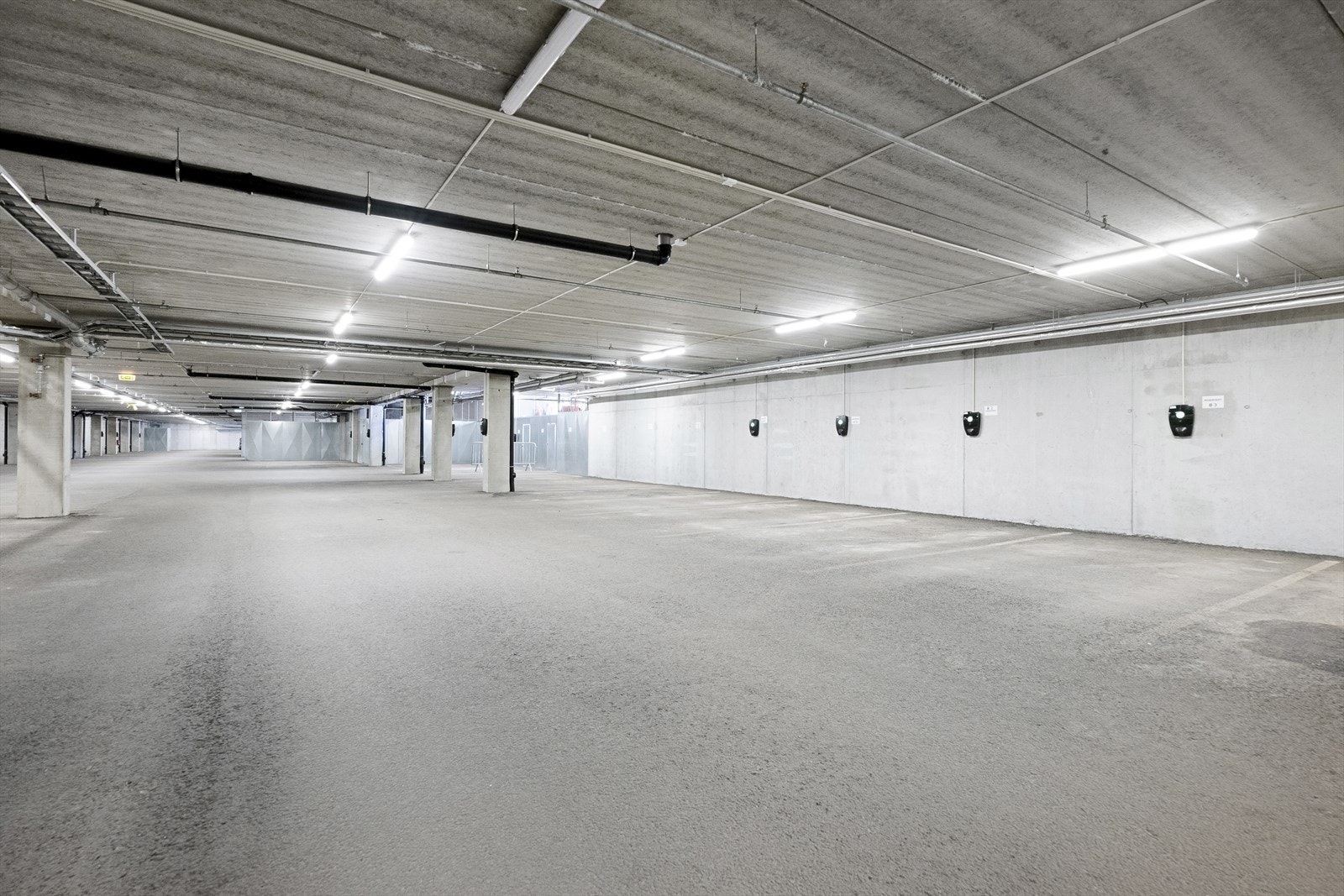 Felles garasjeanlegg. Det er egen, nummerert parkeringsplass med el.billader. Galleribilde