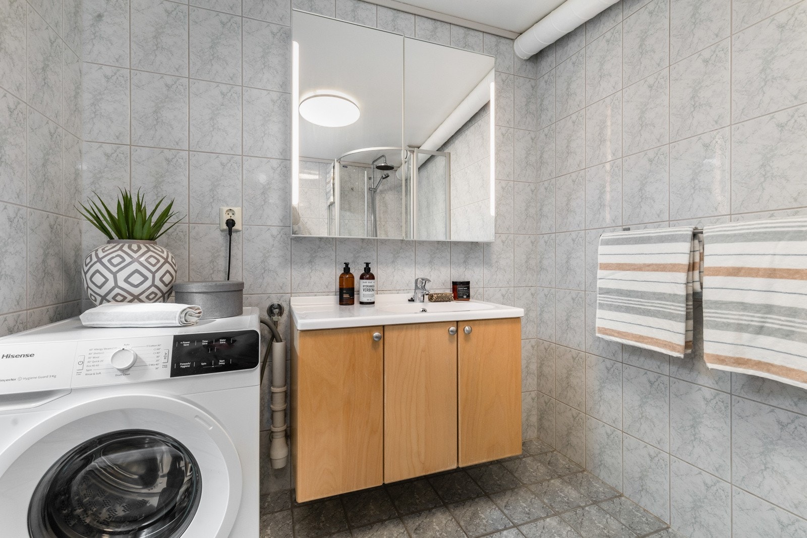 Badet har varmekabler i gulv og opplegg for vaskemaskin. Galleribilde