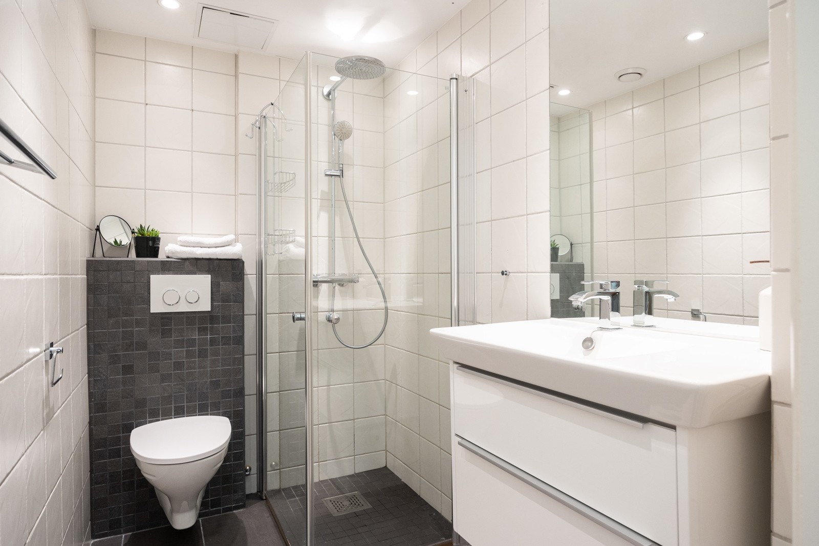 Badet tilknyttet hybeldelen ble pusset opp i 2012 og har dusjhjørne med svingbare glassdører, vegghengt toalett og enkel servant. Galleribilde