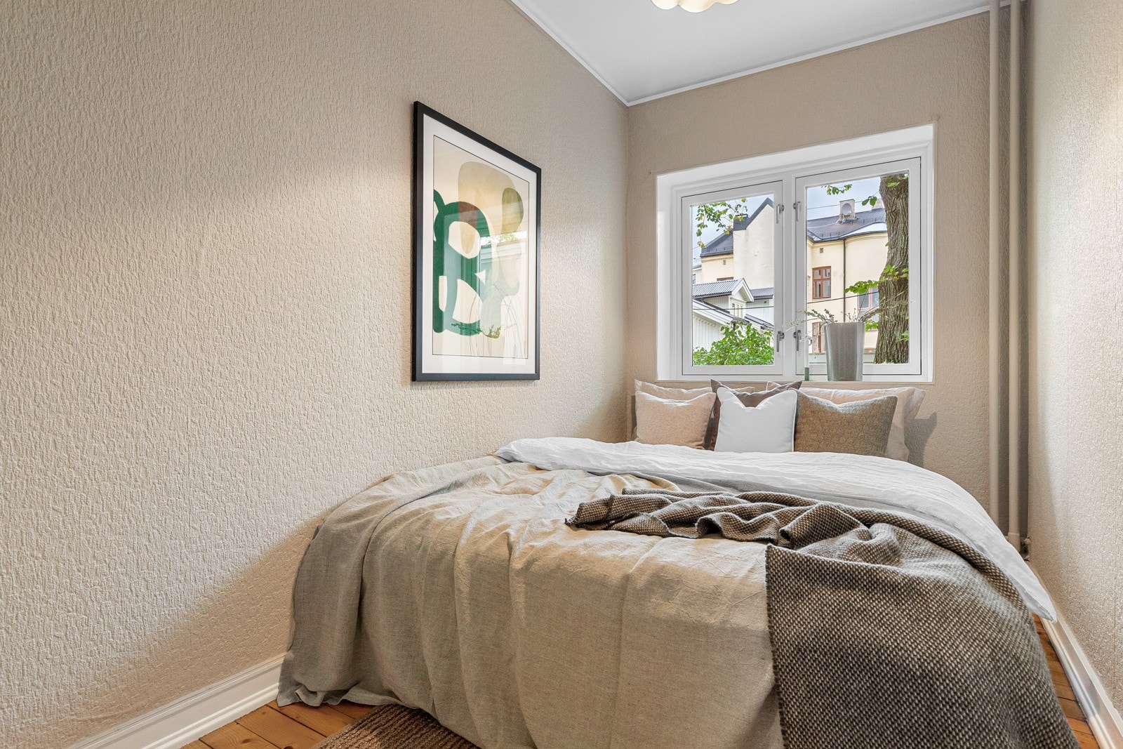 Lyst soverom med plass til seng og garderobeløsning. Stor vindusflate sørger for naturlig lysinnslipp. Galleribilde