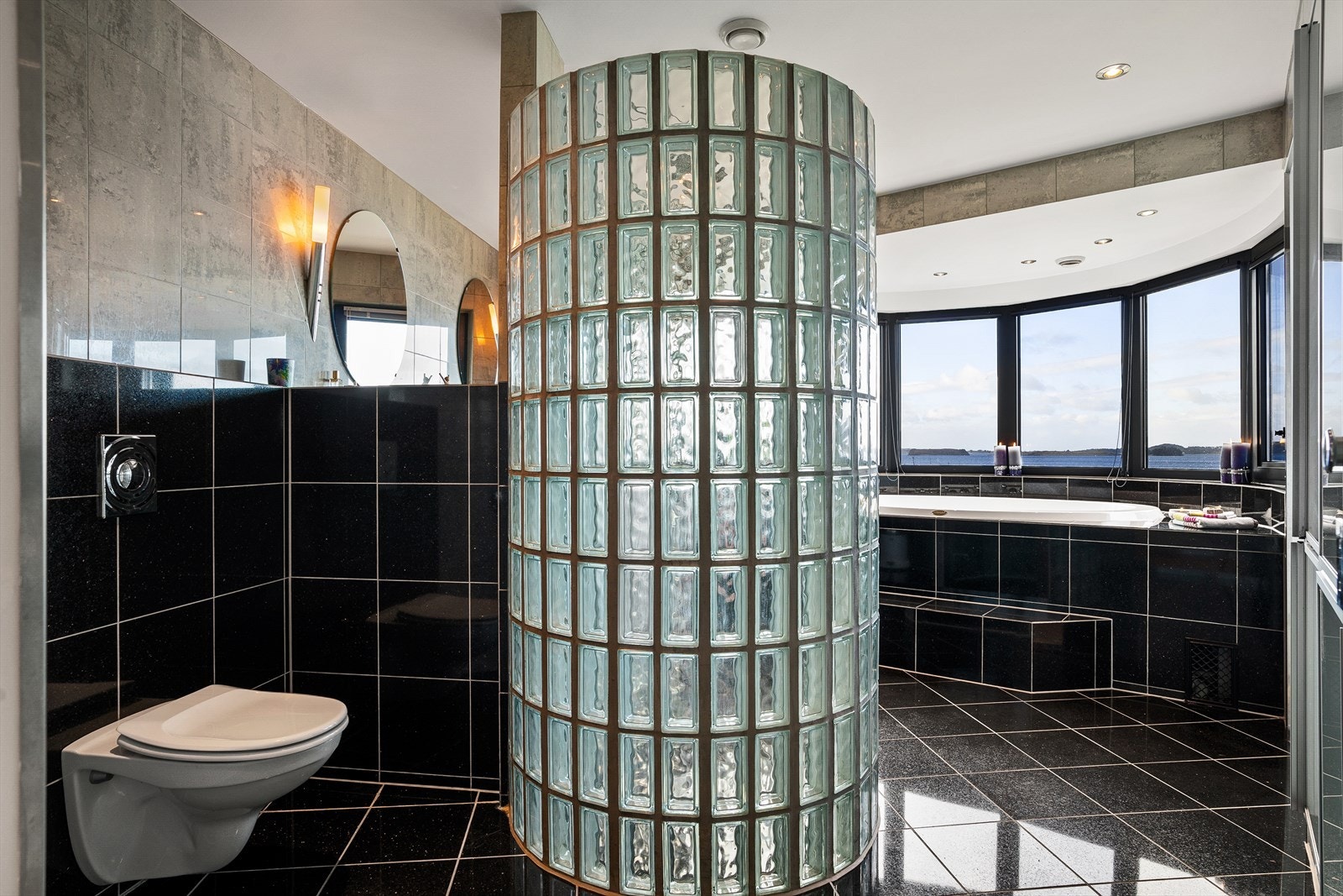 Romslig bad med dusjnisje i glassbyggestein og Jacuzzi Galleribilde