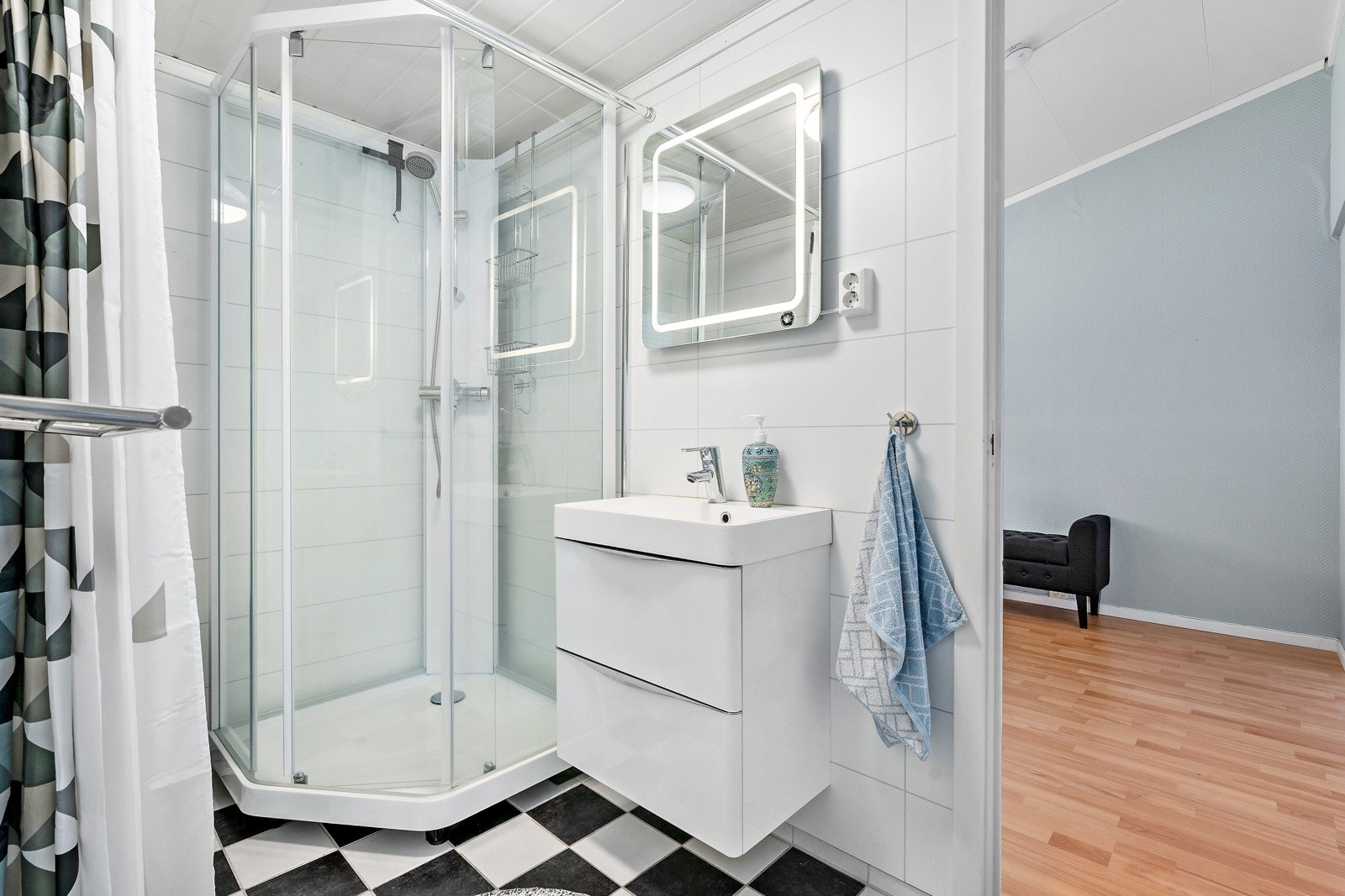 Badet er fra år 2015 med flislagt gulv med gulvvarme. Baderomsinnredningen består av vegghengt servant med skuffer, speil med integrert lys og dusjkabinett Galleribilde