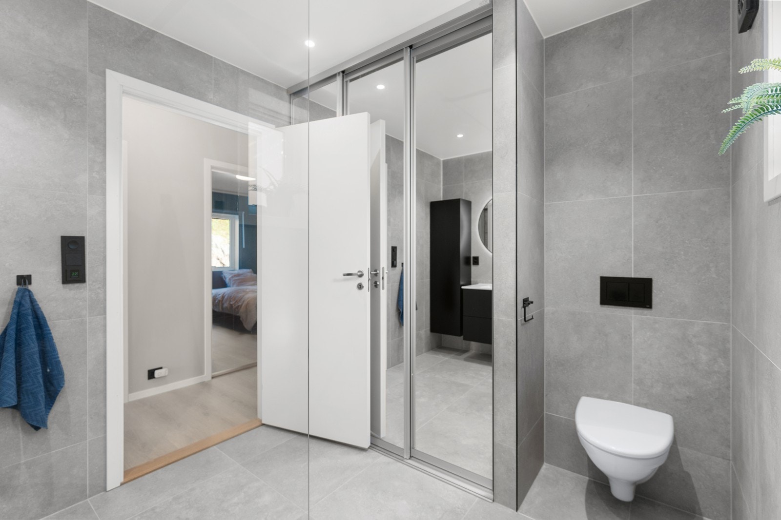 Opplegg til vaskemaskin/tørketrommel bak skyvedør i speil, samt varmtvannstank. Galleribilde