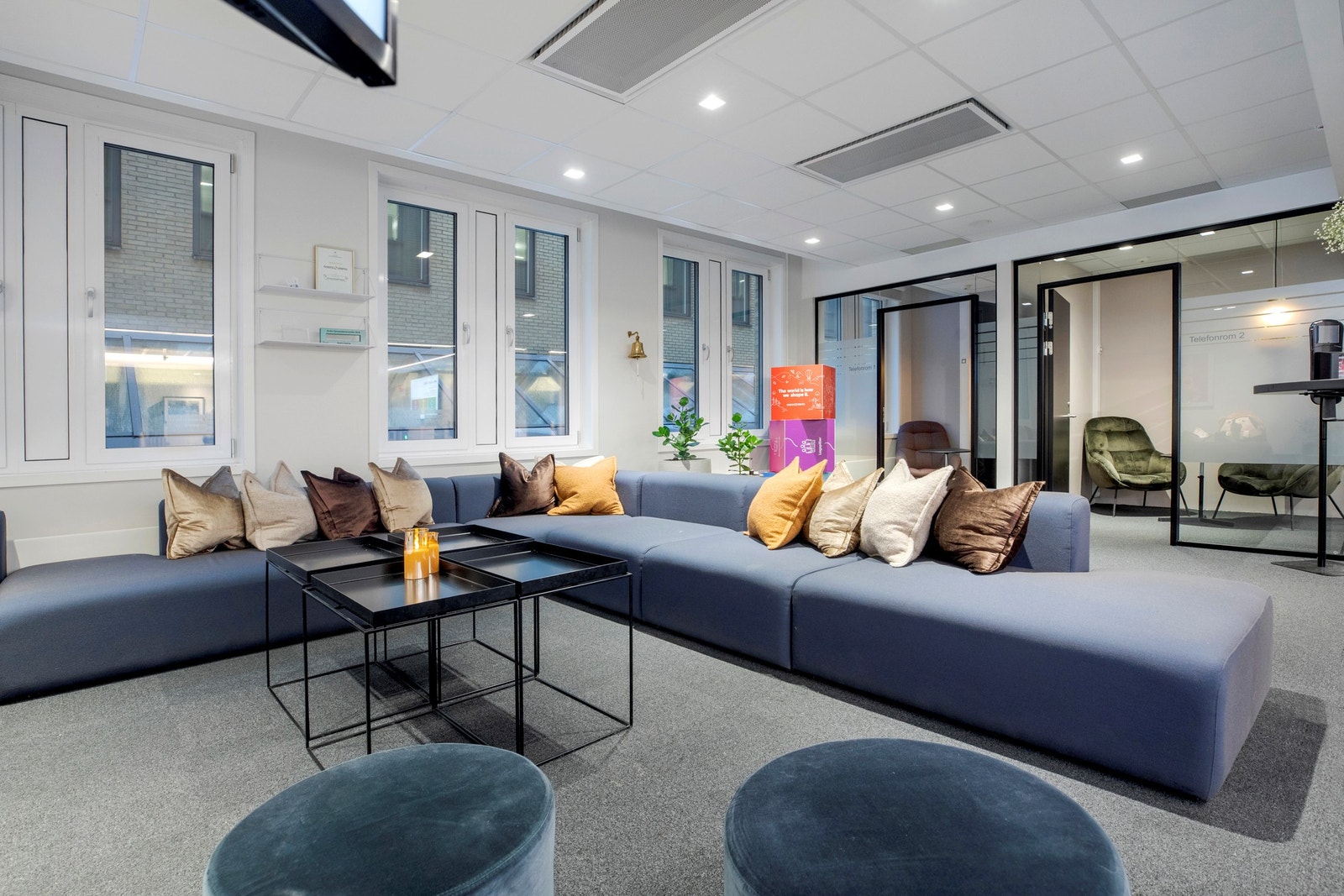 Store vinduer sørger for rikt, naturlig lysinnslipp og vegg-til-vegg teppe skaper et stille innemiljø. Galleribilde