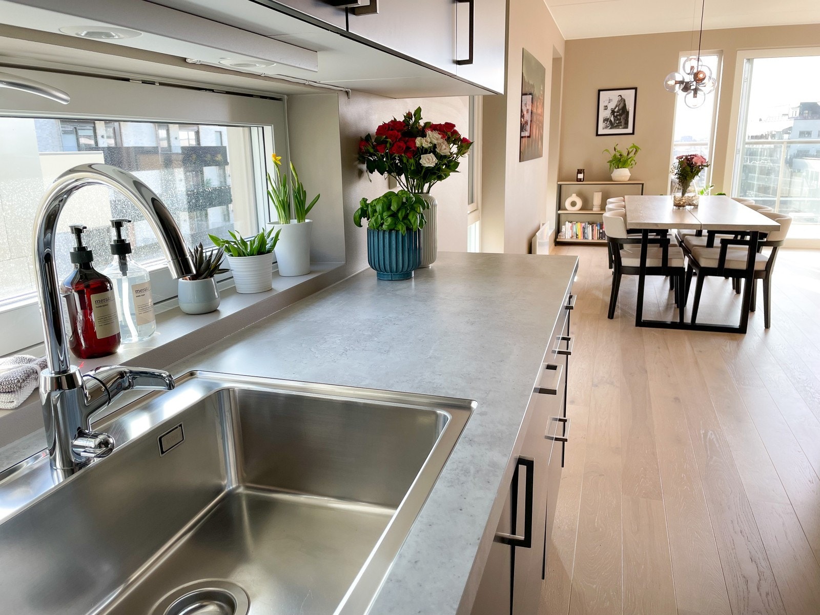 Åpen kjøkkenkrok inn mot stue og spisebord Galleribilde