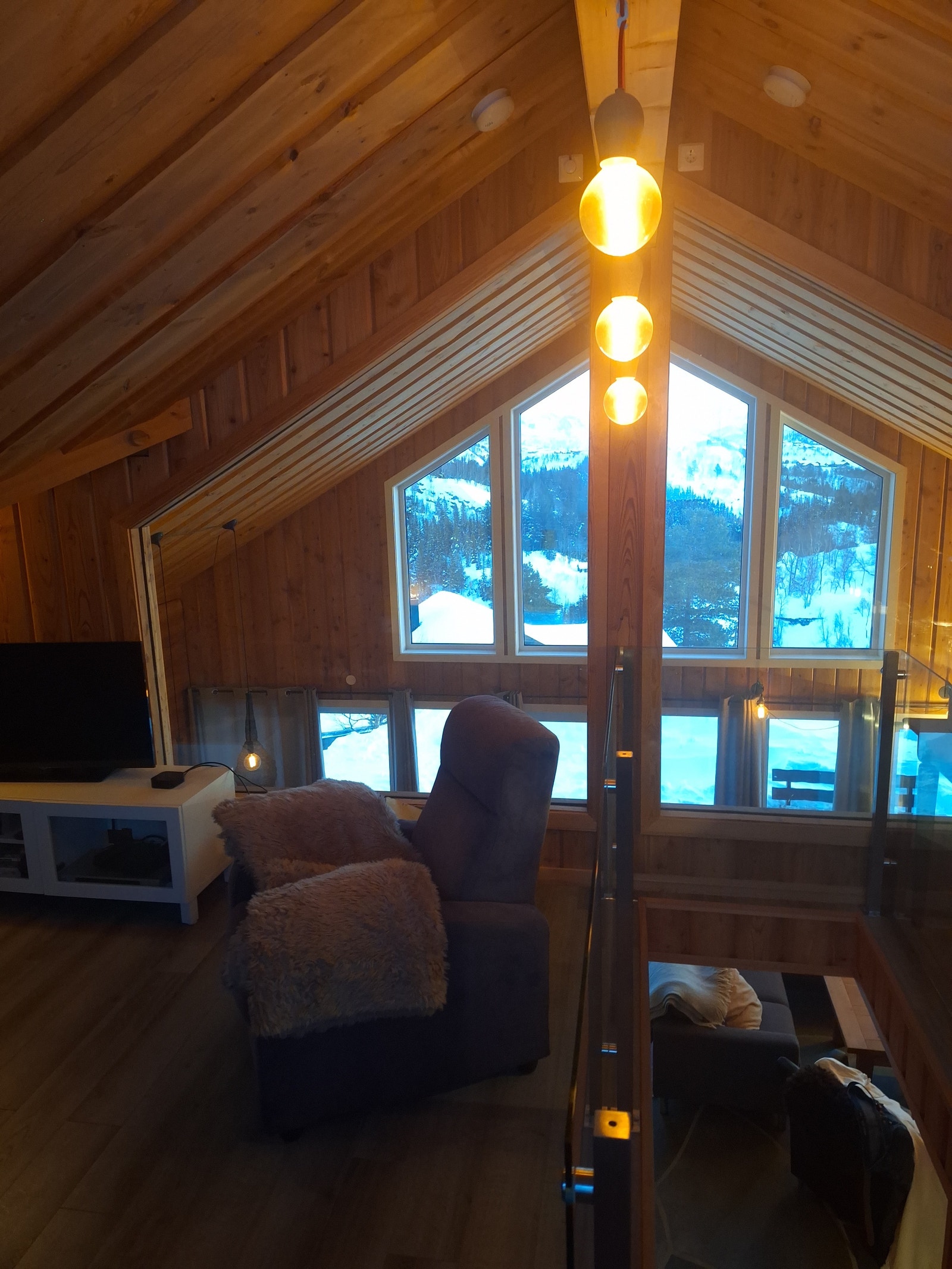 Loftstue med blant annet sovesofa, TV, Apple-TV og bord til diverse hobbyaktiviteter Galleribilde