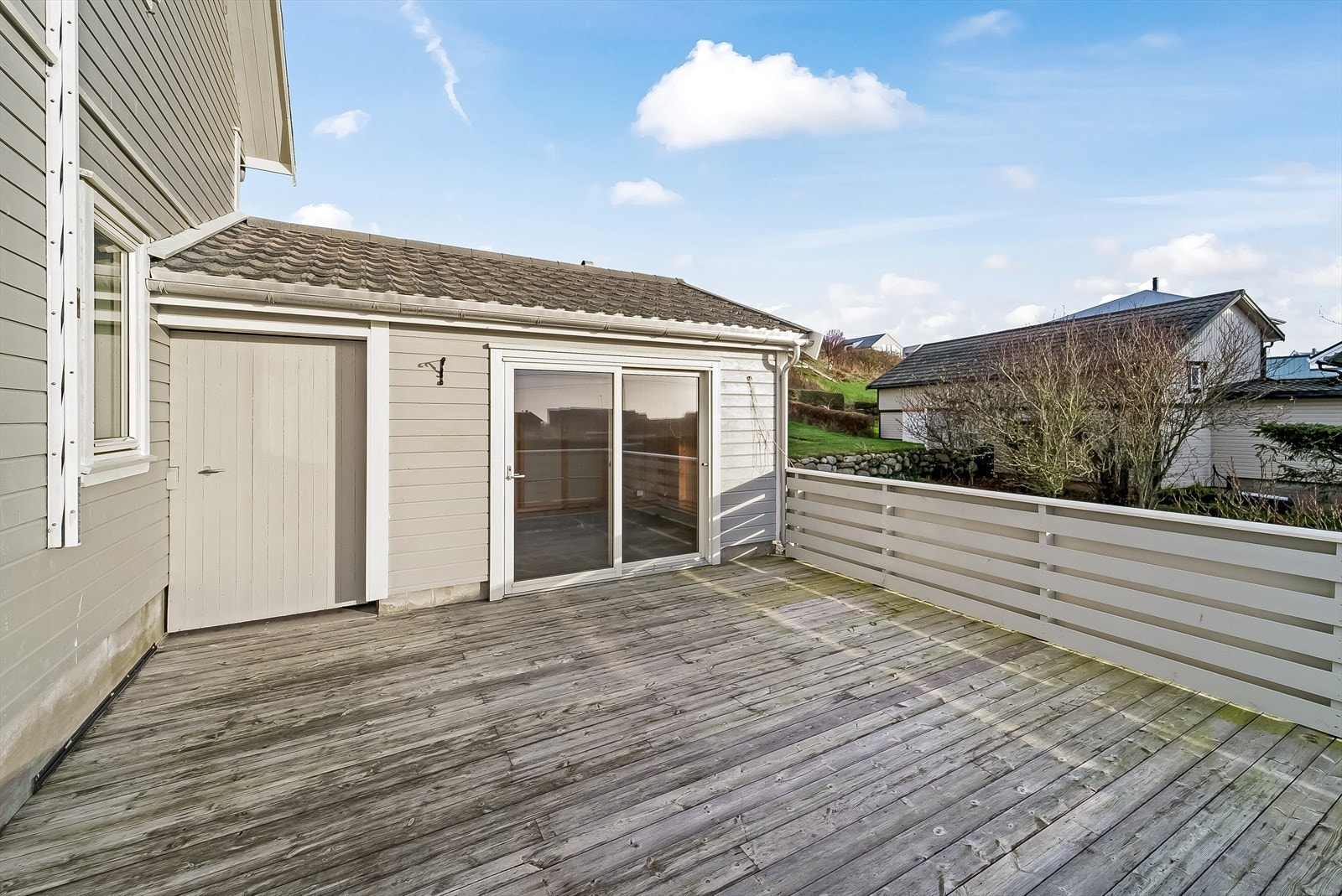 Romslig terrasse med adkomst fra hage, via dør fra carporten og stuen. Galleribilde