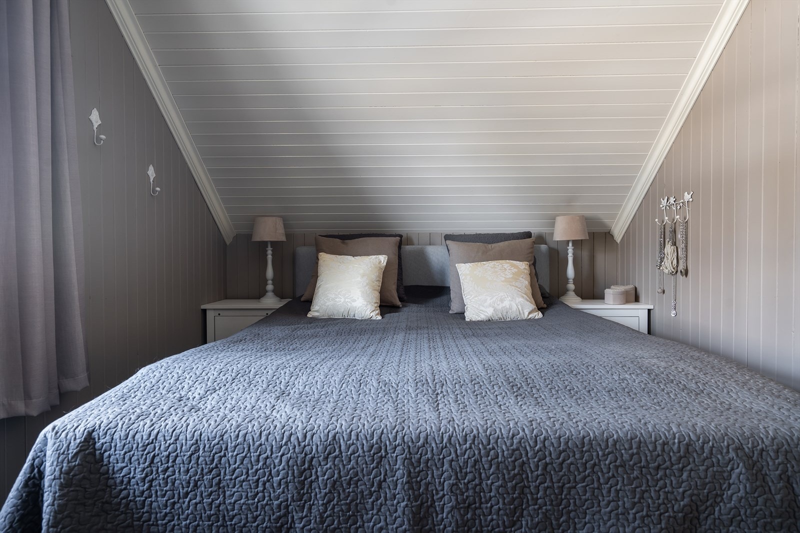 Eneboligen har tre soverom med skrå himlinger og malt veggpanel, som alle ligger plassert i andre etasje. Galleribilde