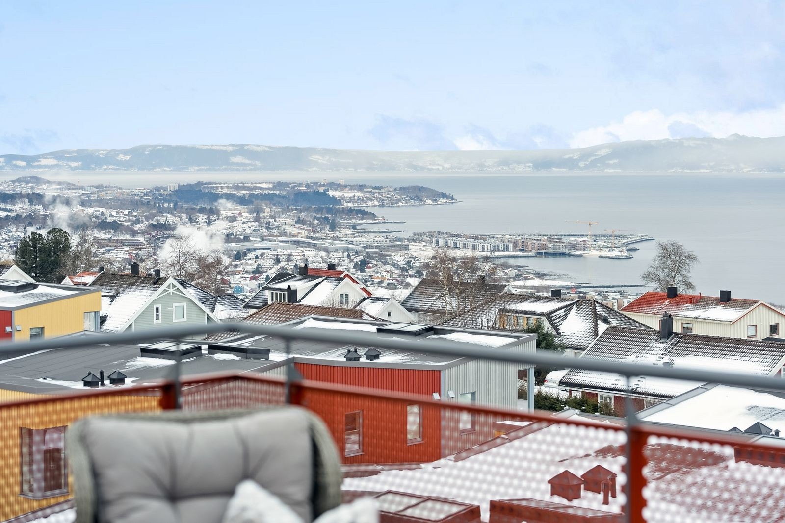 Ta deg en pust i bakken mens du skuer utover fjorden med fjellene i det fjerne. Galleribilde