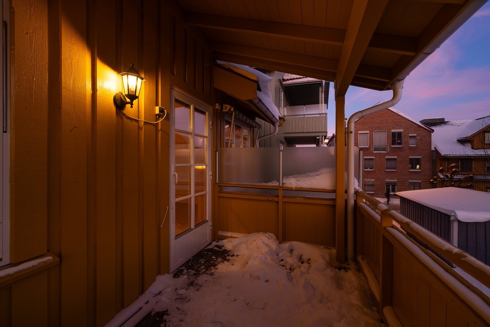 Balkongen har takoverbygg og utelys. Galleribilde