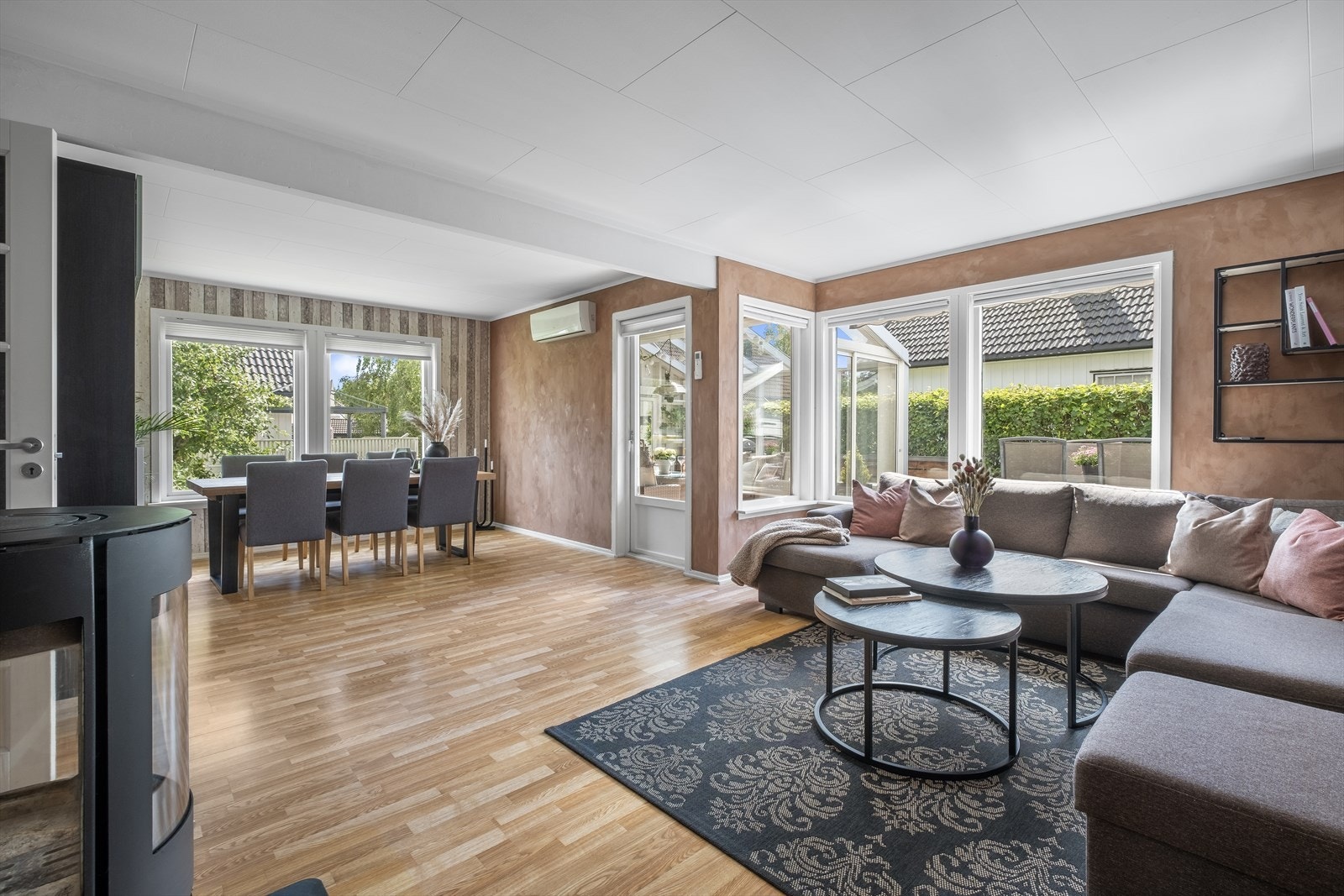 Stuen har mye naturlig lys inn og det er varmepumpe og peisovn i rommet. Det er også utgang til vinterhage Galleribilde