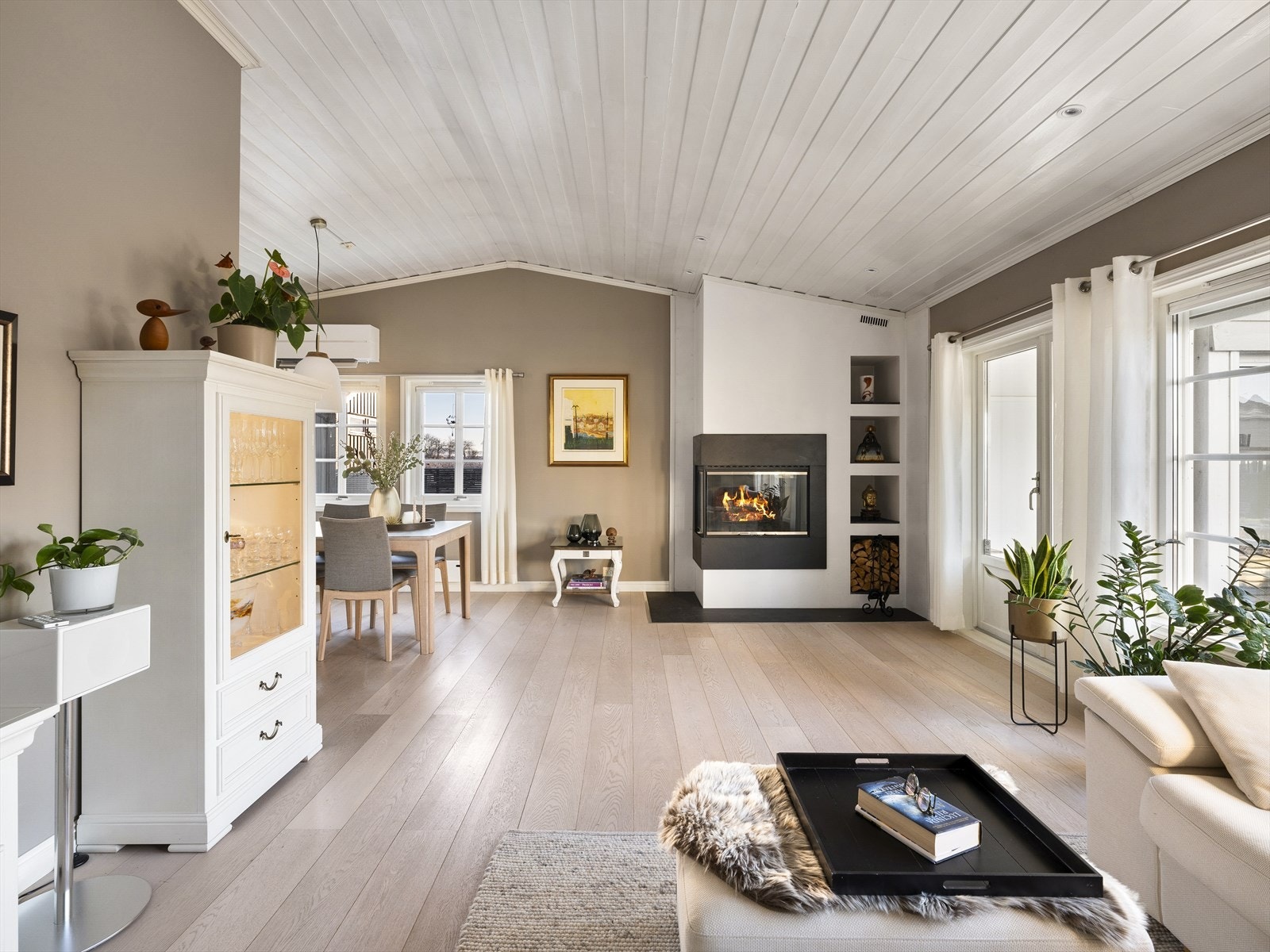 Innfelt vedovn med praktisk hyllesystem for lagring av ved. I tillegg er det montert varmepumpe ved spisesone. Galleribilde