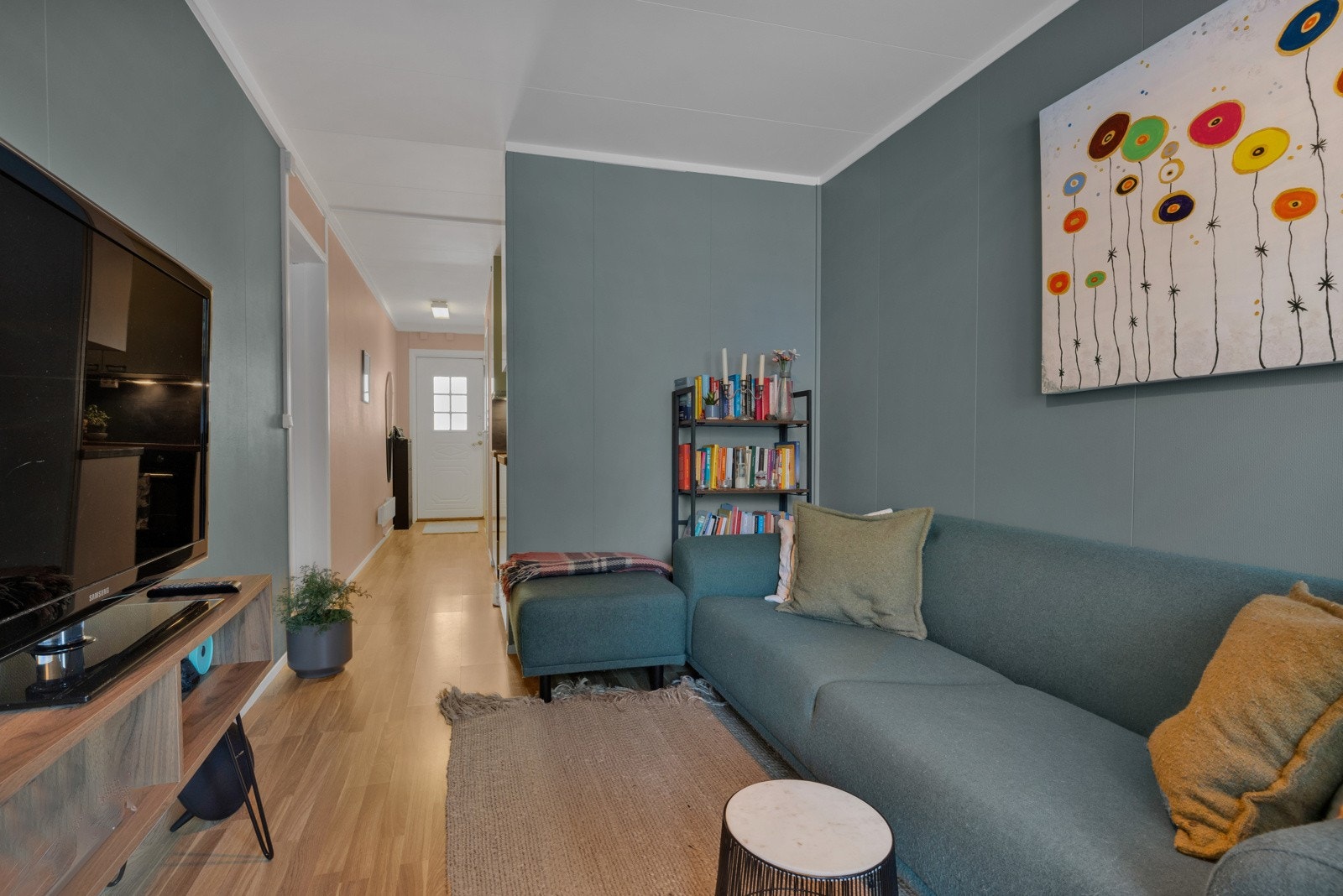 Stuen er tiltalende med laminatgulv og vegger i en lun og trendy farge Galleribilde