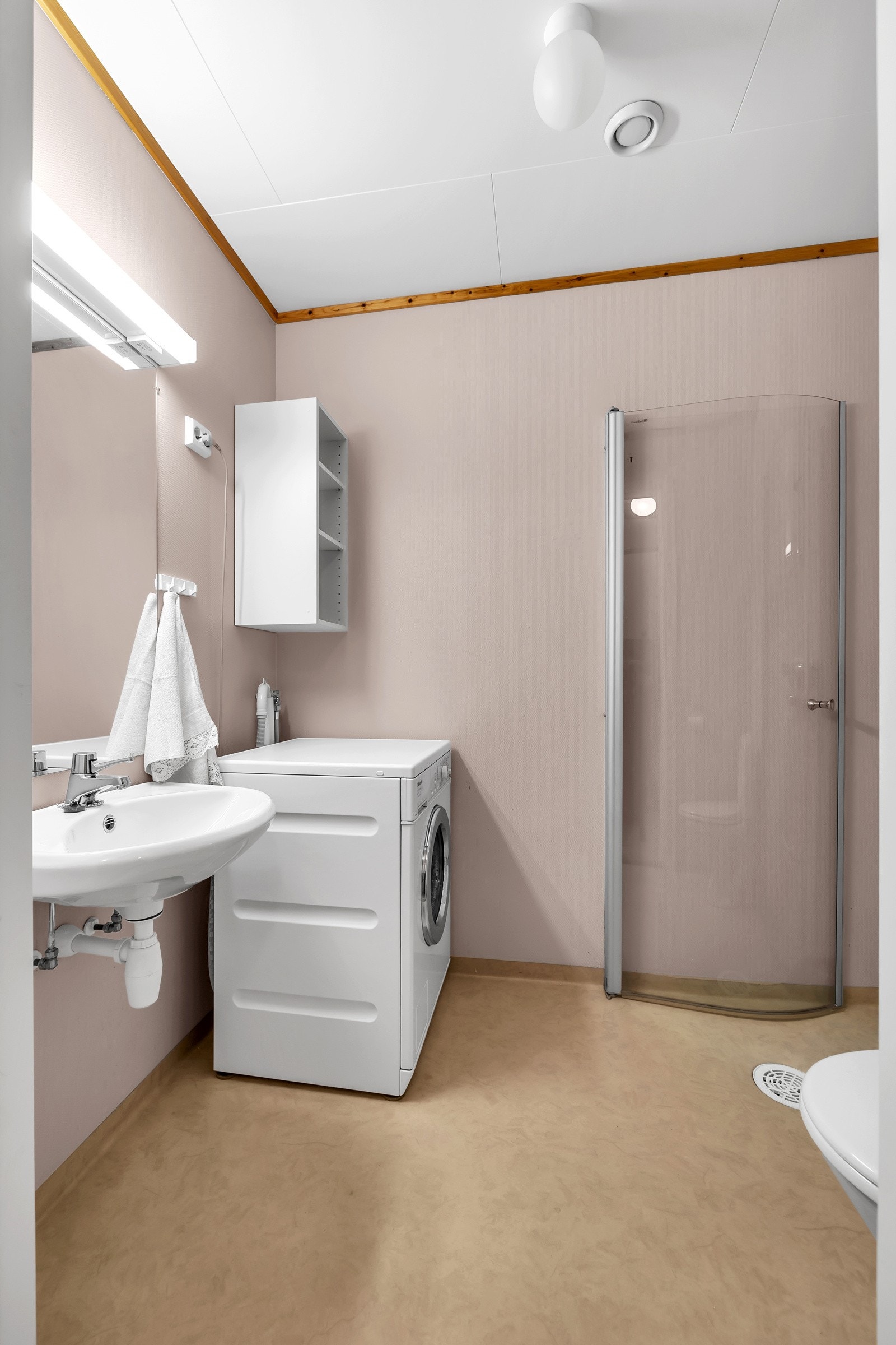 Badet til hybelen er praktisk med dusj, WC og opplegg for vaskemaskin Galleribilde