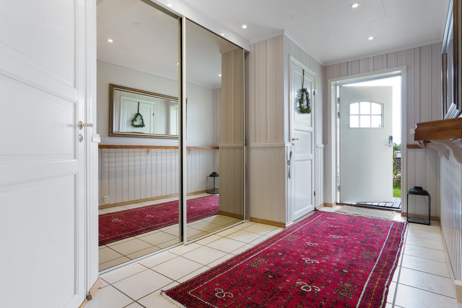Hovedentréen i underetasjen har godt med oppbevaringsplass både i skyvedørsgarderobe og tilhørende bod. I trappeoppgangen er det etablert en varmepumpe på 6,6 kw. Galleribilde