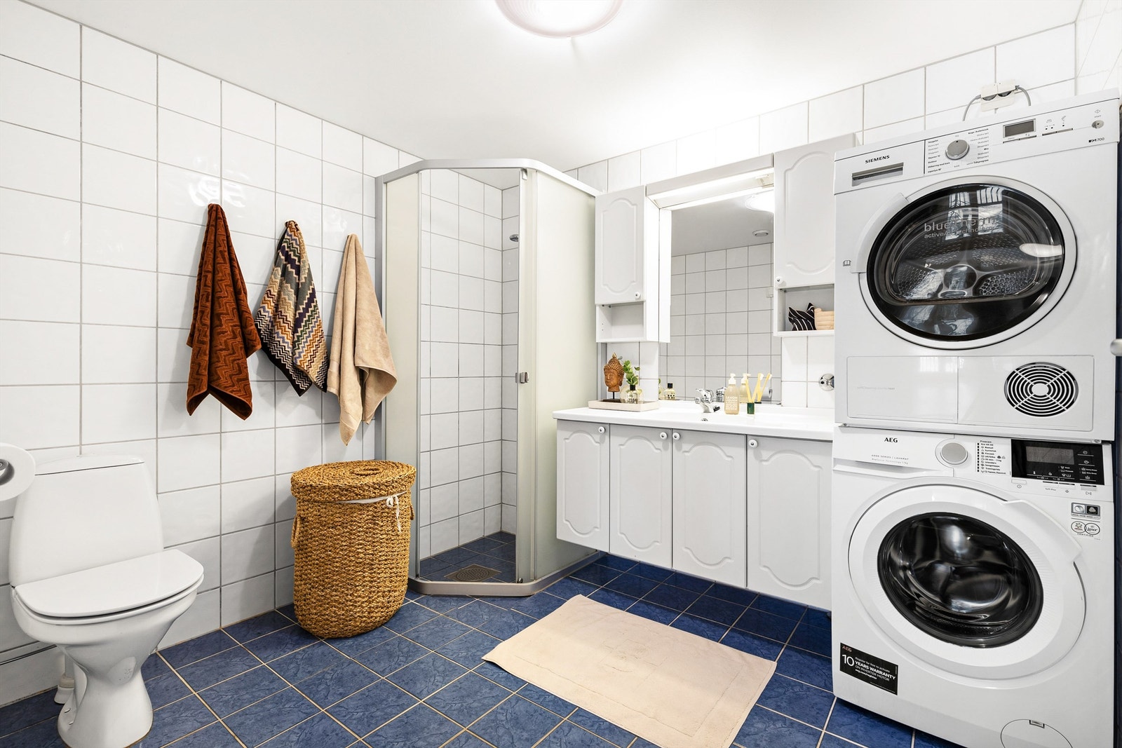 Bad/vaskerom fra byggeår. Flislagt gulv med varme, flislagte vegger og malt himling. Galleribilde