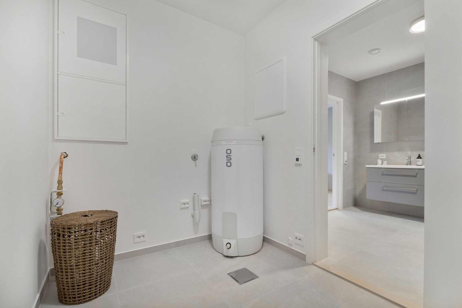 Romslig bod/vaskerom tilknyttet badet, med opplegg for vaskemaskin og tørketrommel. Galleribilde