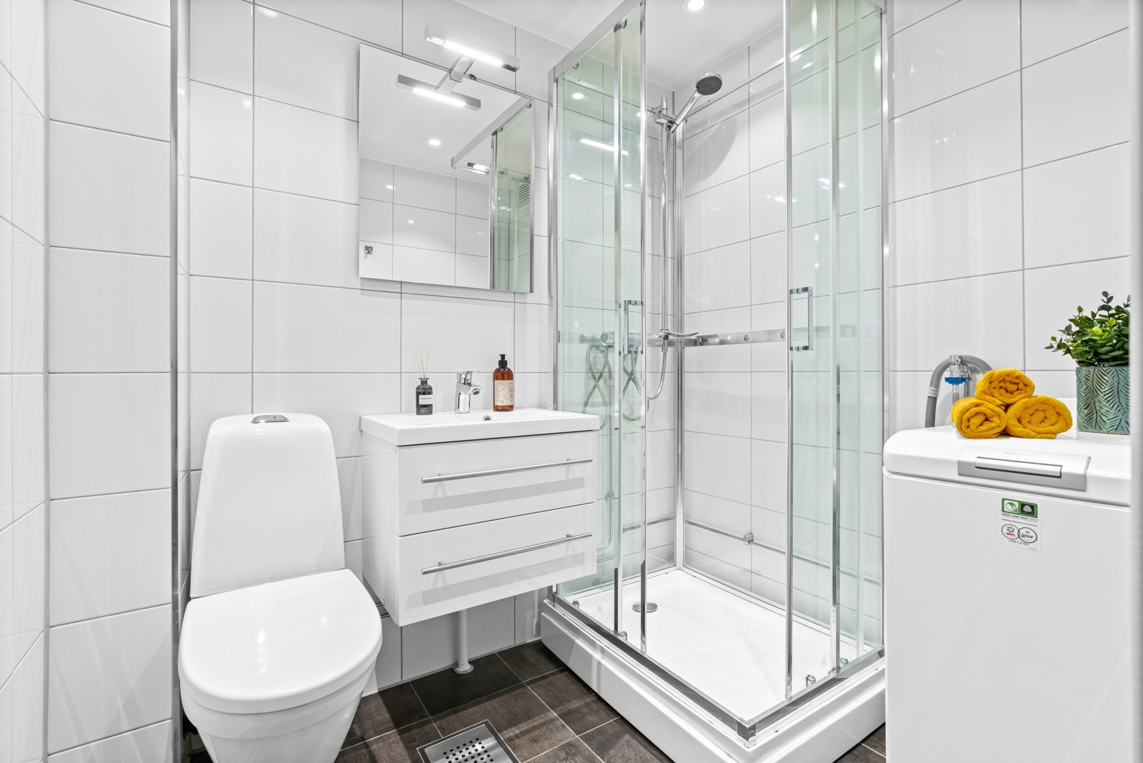 Flislagt baderom som ble totalt modernisert i regi av borettslaget i 2002, overflateopppusset i 2020 med nye fliser og innredning Galleribilde