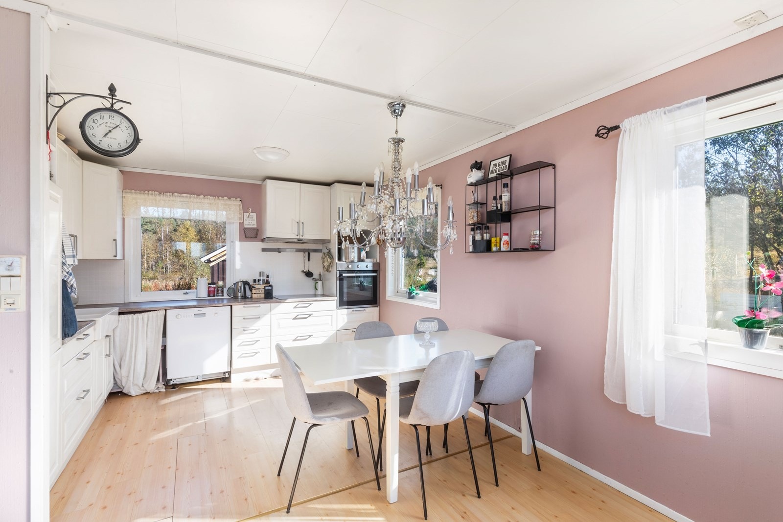 Kjøkken har hvit innredning med eik benkeplate Galleribilde