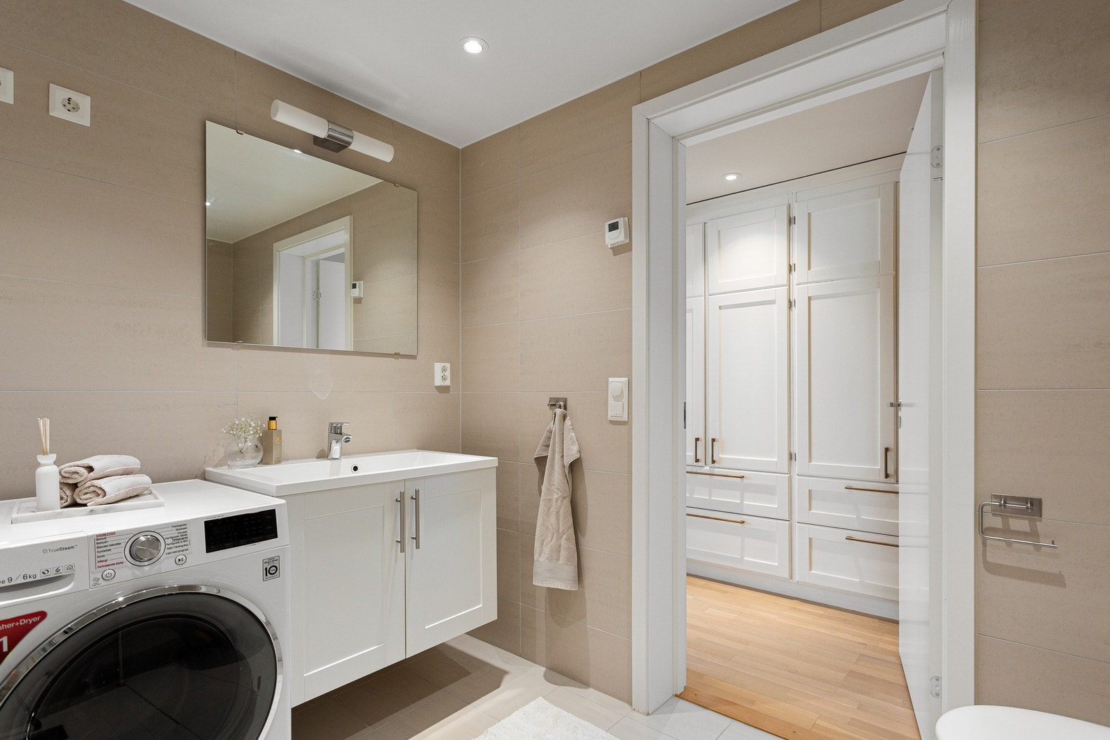 Det er vegghengt toalett og dusjhjørne med innfellbare glassdører som frigjør plass på gulvet. Badet har opplegg for vaskemaskin. Galleribilde