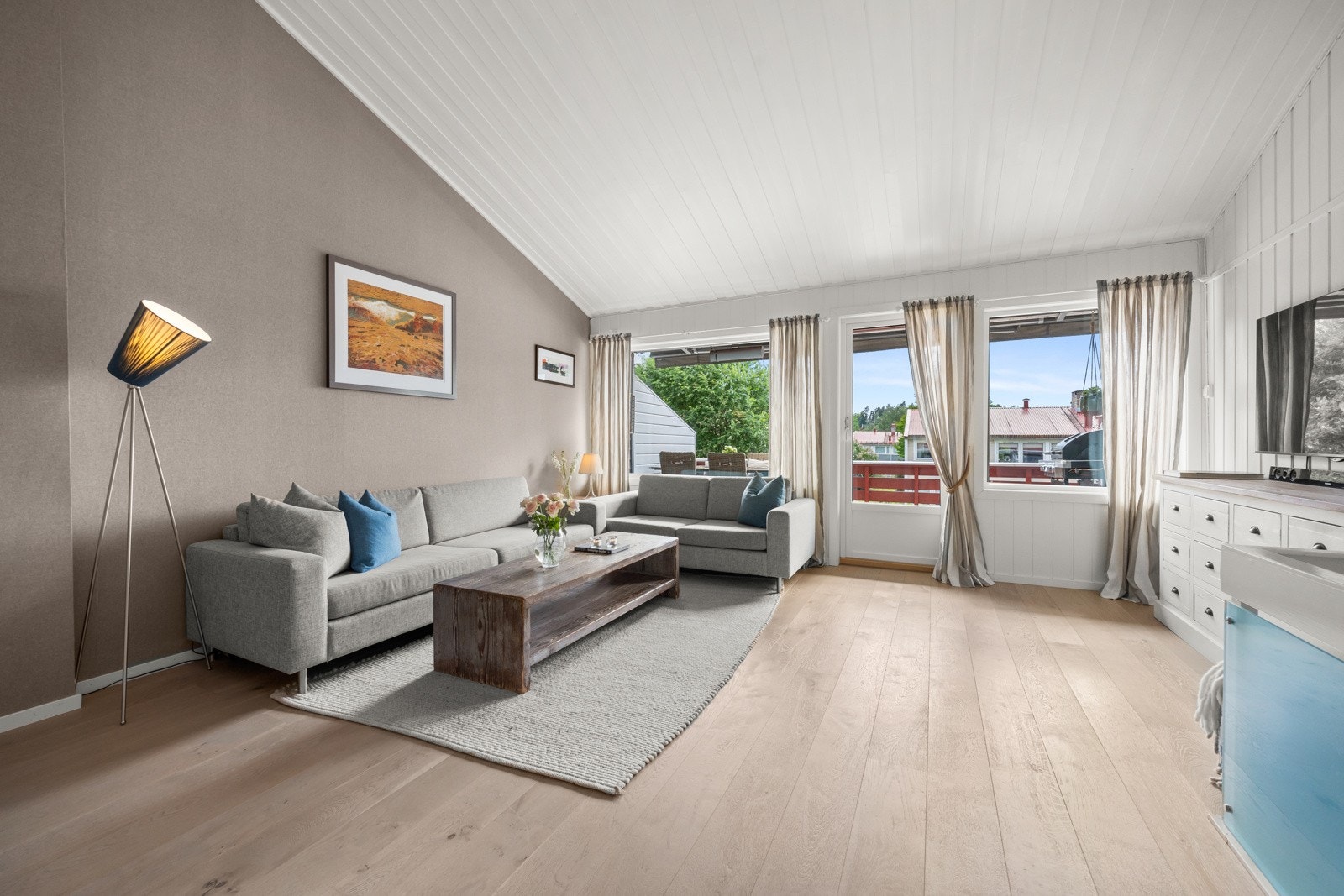 Stuen får rikelig med lysinnslipp takket være de store vindusflatene. Galleribilde