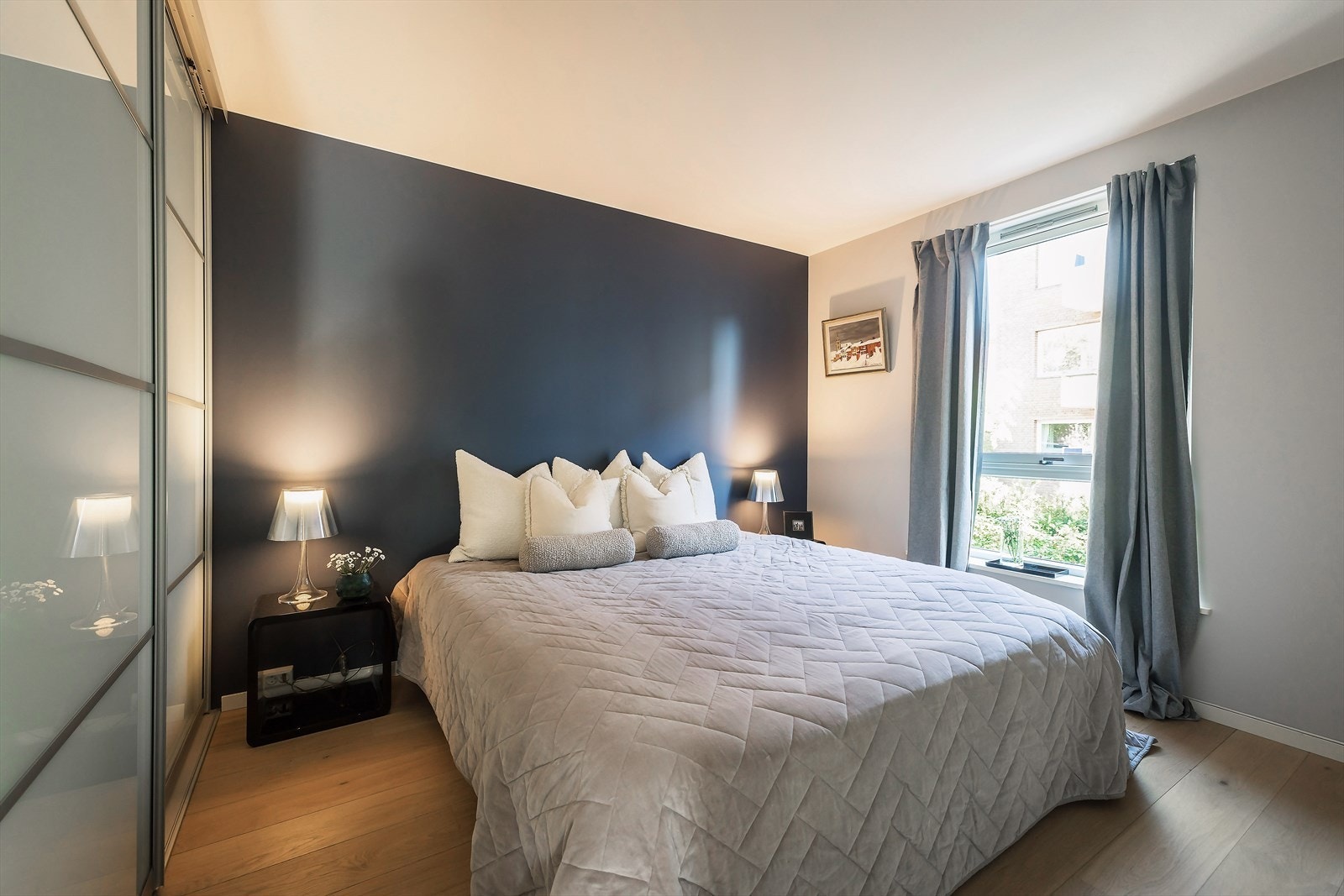 Hovedsoverom med god plass til dobbeltseng, nattbord og skyvedørsgarderobe. Galleribilde