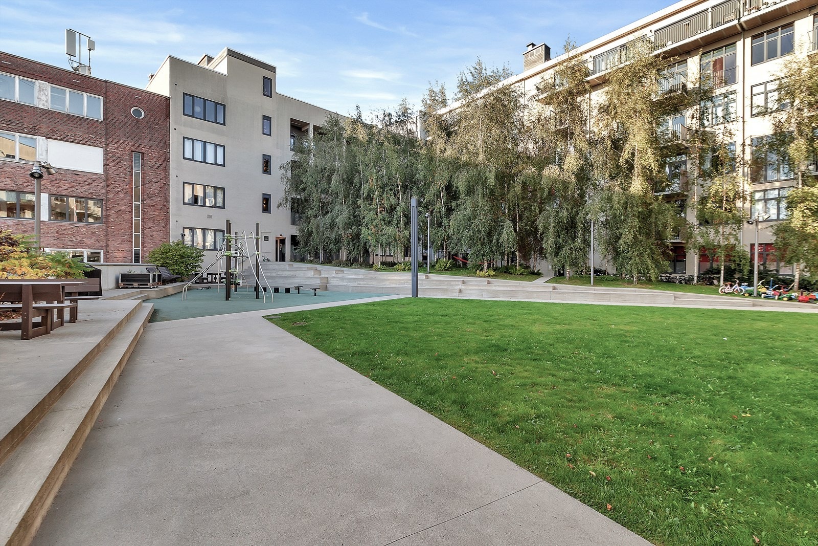 Flott bakgård med sittegrupper og lekestativ for de minste. Galleribilde