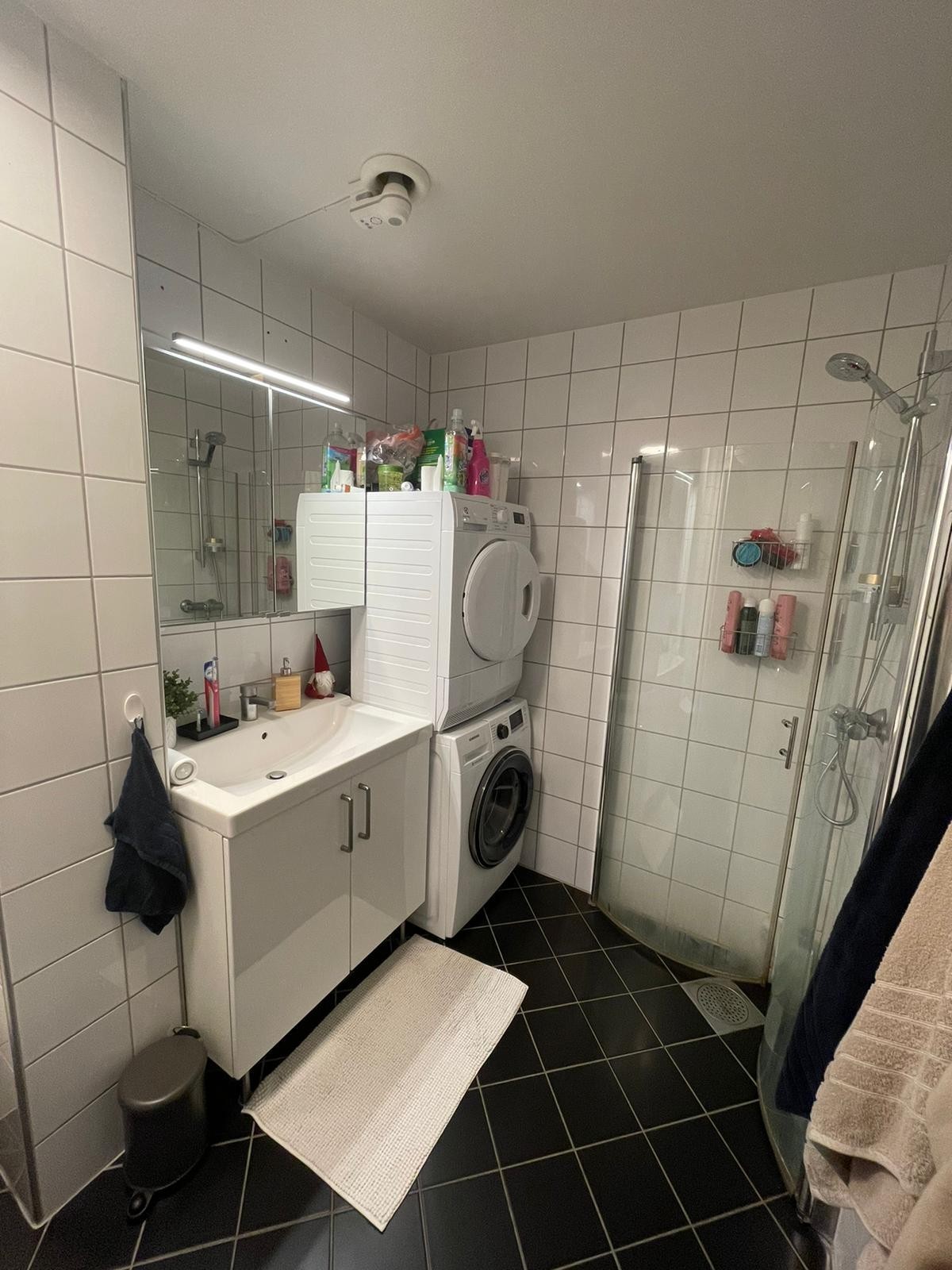Helfliset bad med varmekabler i gulvet. Dusjhjørne i glass og vaskemaskin og tørketrommel. Galleribilde