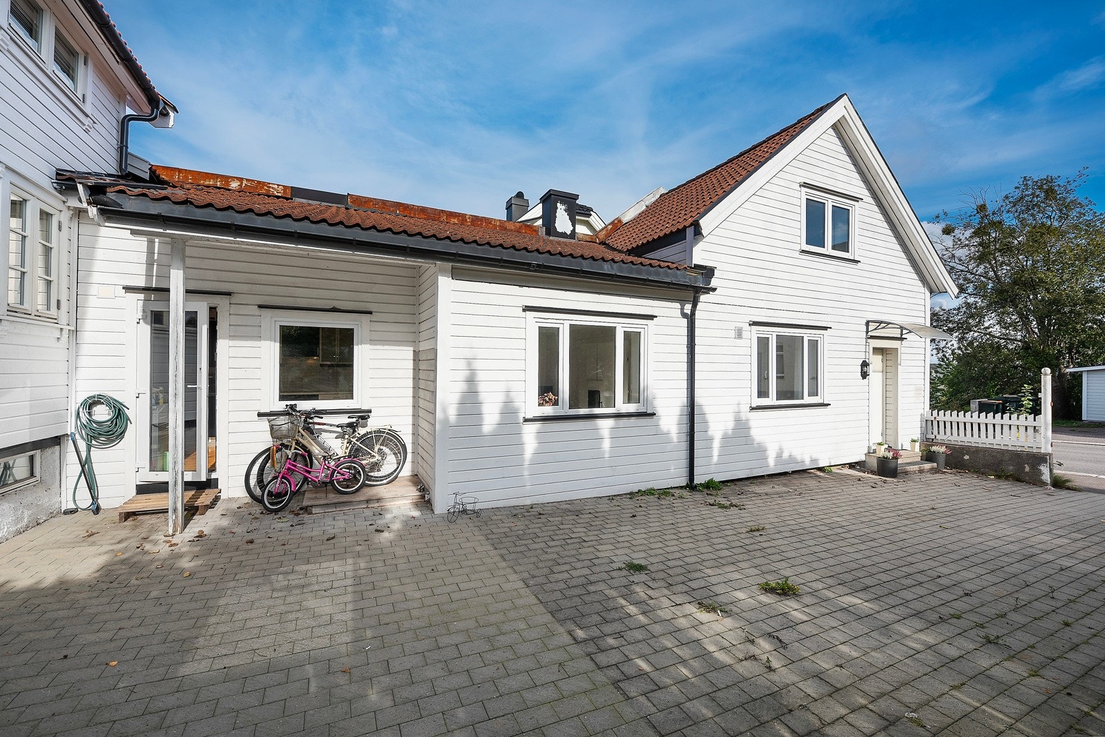 Utenfor boligen er en stor stenlagt gårdsplass Galleribilde