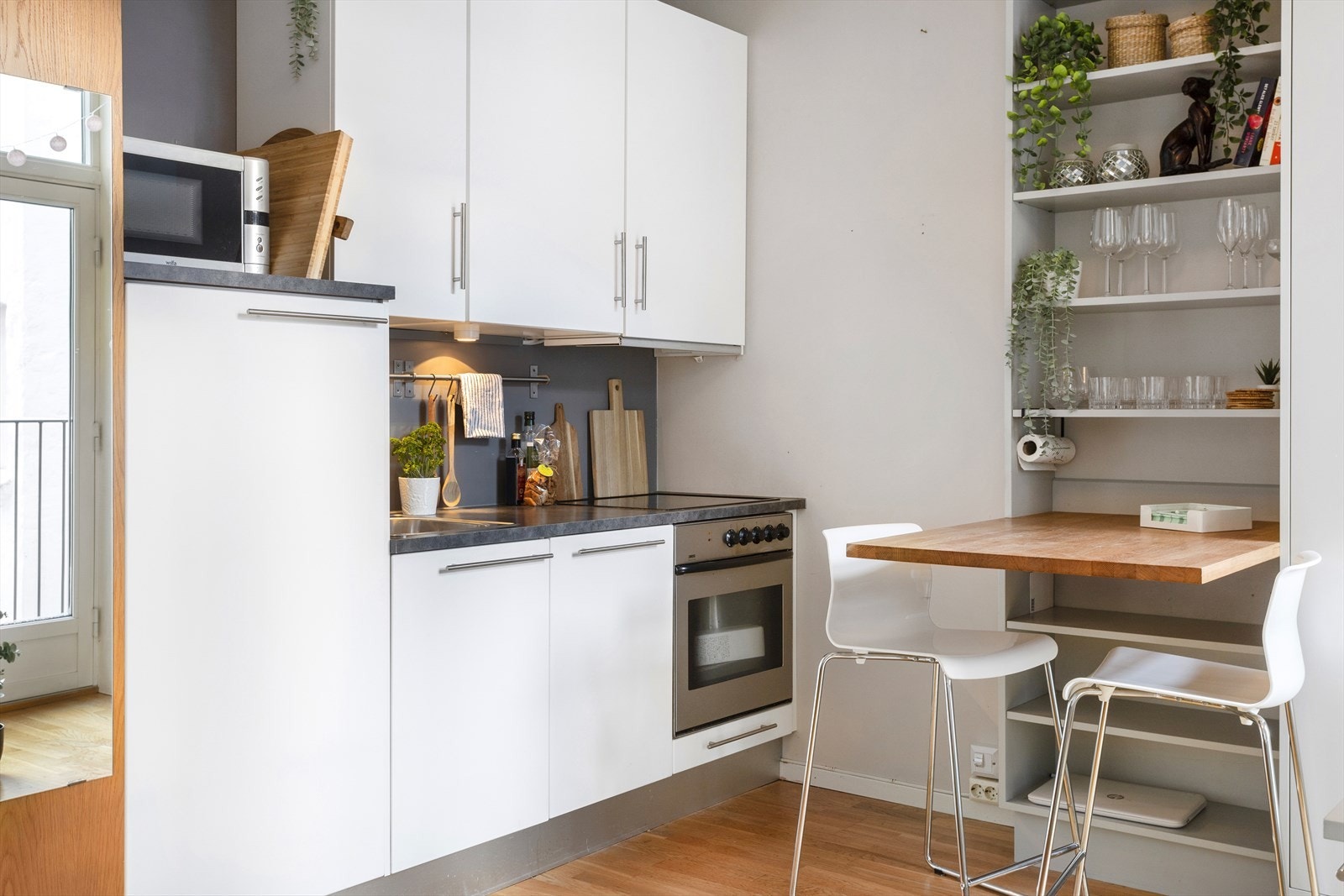 Til høyre er det bygget en bokhylle med integrert bordplate som skaper en hyggelig spiseplass. Galleribilde